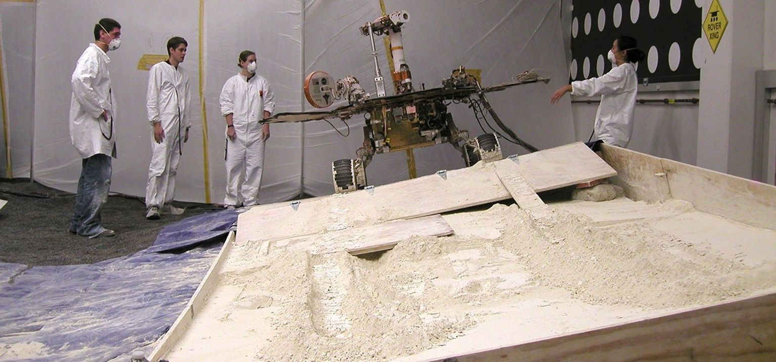 Rover team members at NASA's Jet Propulsion Laboratory, Pasadena, Calif., on July 24, 2009, discuss the next step in preparing for a new phase in testing of possible moves for getting NASA's Mars rover Spirit out of a sandtrap on Mars.