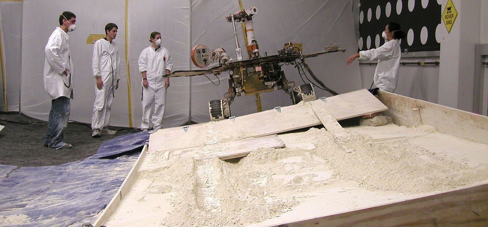 Rover team members at NASA's Jet Propulsion Laboratory, Pasadena, Calif., on July 24, 2009, discuss the next step in preparing for a new phase in testing of possible moves for getting NASA's Mars rover Spirit out of a sandtrap on Mars.