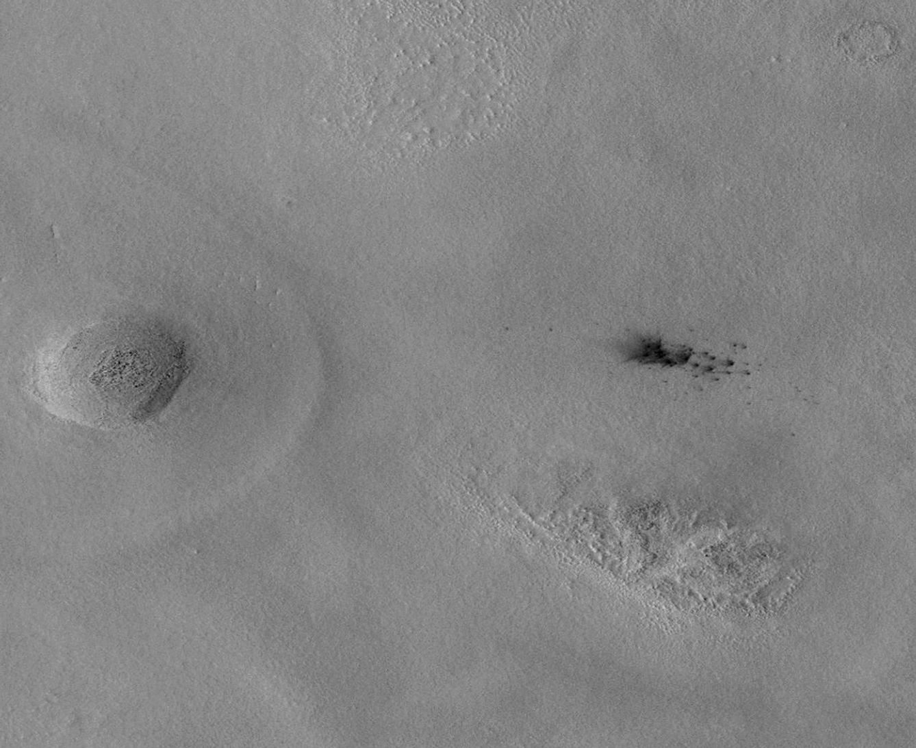 The Context Camera aboard NASA's Mars Reconnaissance Orbiter discovers new dark spots on Mars that, upon closer examination, turn out to be brand new impact craters.