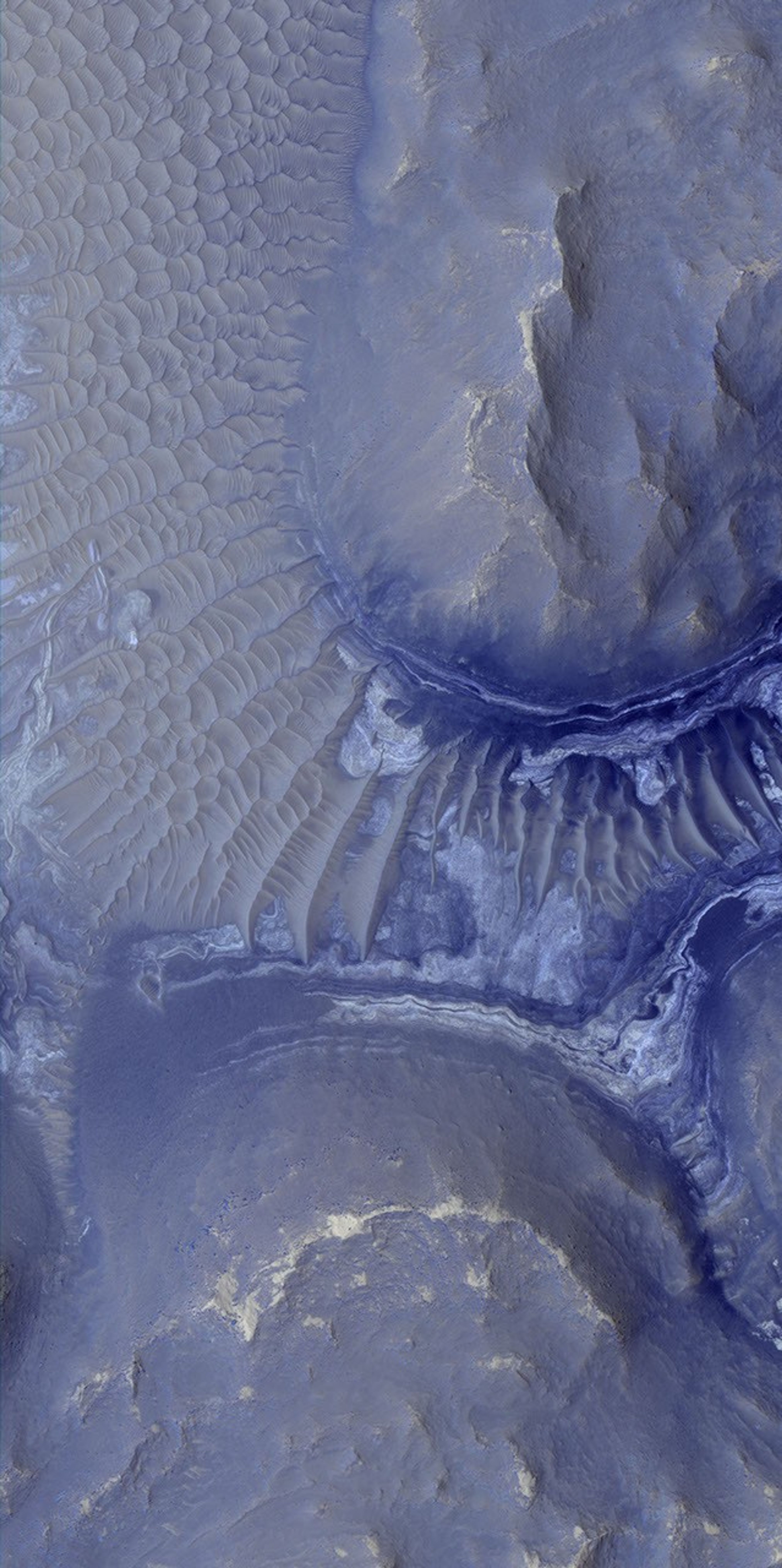 Layers in the lower portion of two neighboring buttes within the Noctis Labyrinthus formation on Mars are visible in this image from NASA's Mars Reconnaissance Orbiter.