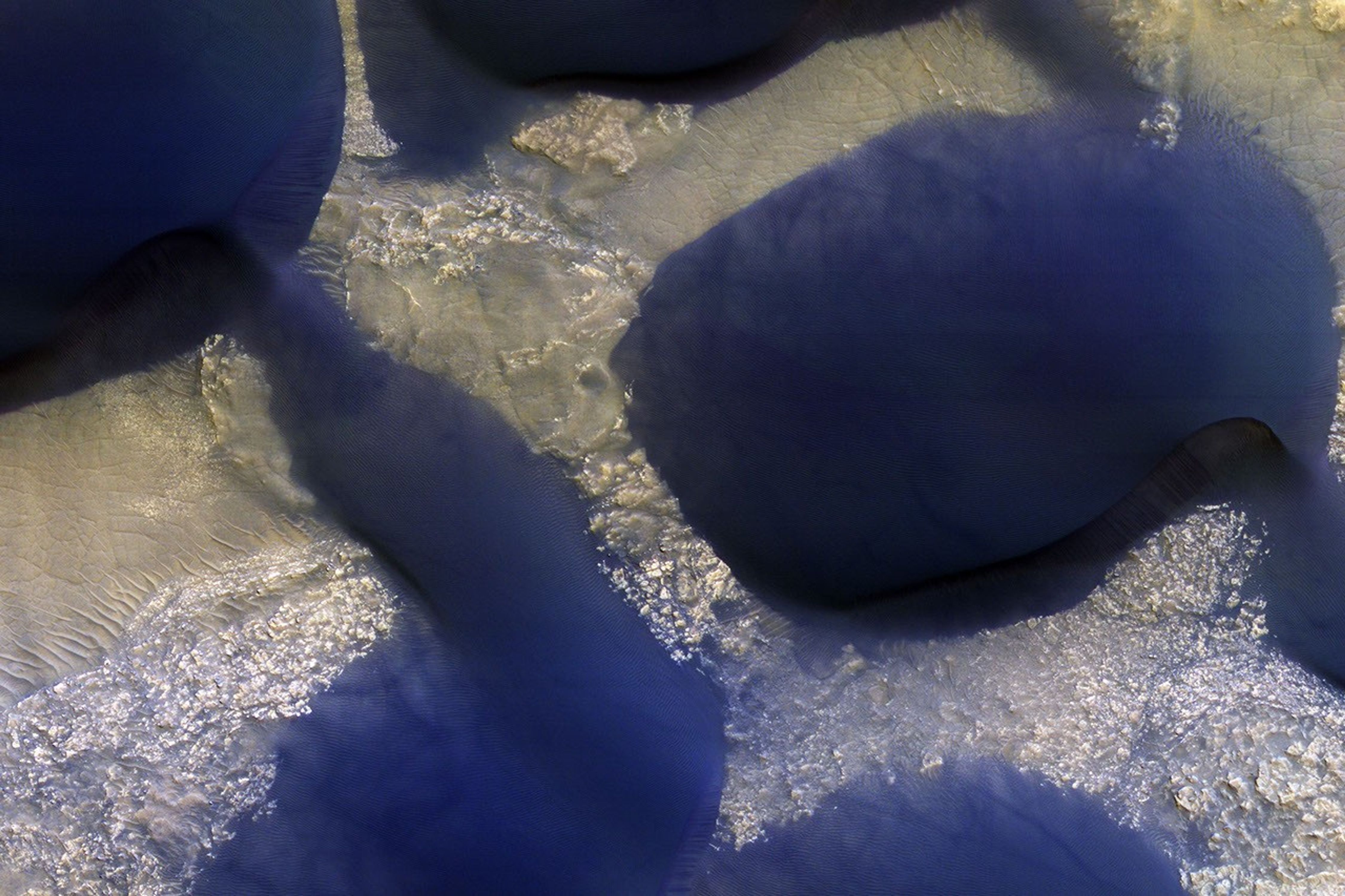 The large dark feature is a classic Martian sand dune on Wirtz Crater as seen by NASA's Mars Reconnaissance Orbiter.
