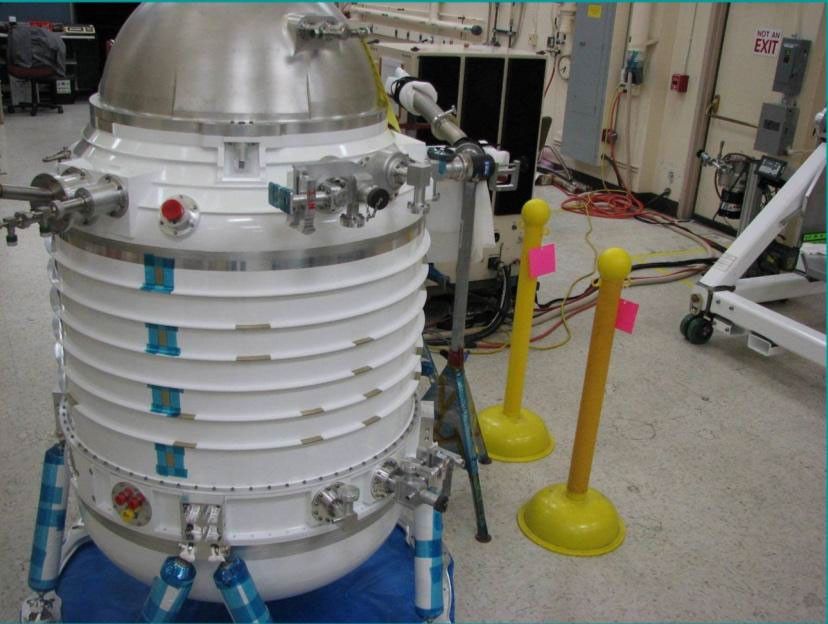 Initial assembly of NASA's Wide-field Infrared Survey Explorer cryostat. The cryostat is a 2-stage solid hydrogen dewar that is used to cool the WISE optics and detectors. Here the cryostat internal structures are undergoing their initial vacuum pumpdown.