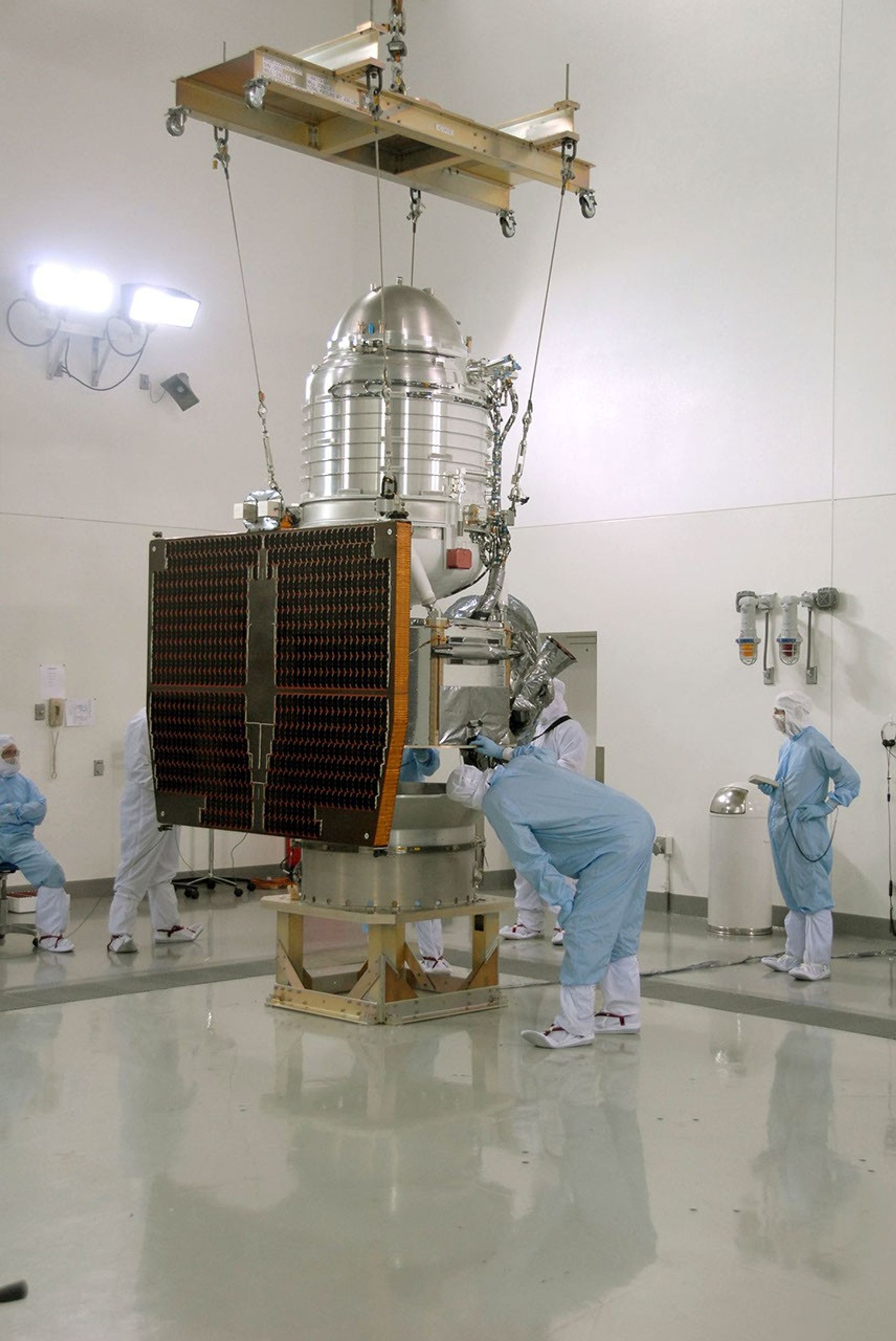 At Vandenberg Air Force Base's Astrotech processing facility in California, NASA's Wide-field Infrared Survey Explorer, or WISE, spacecraft is being lifted from a work stand.