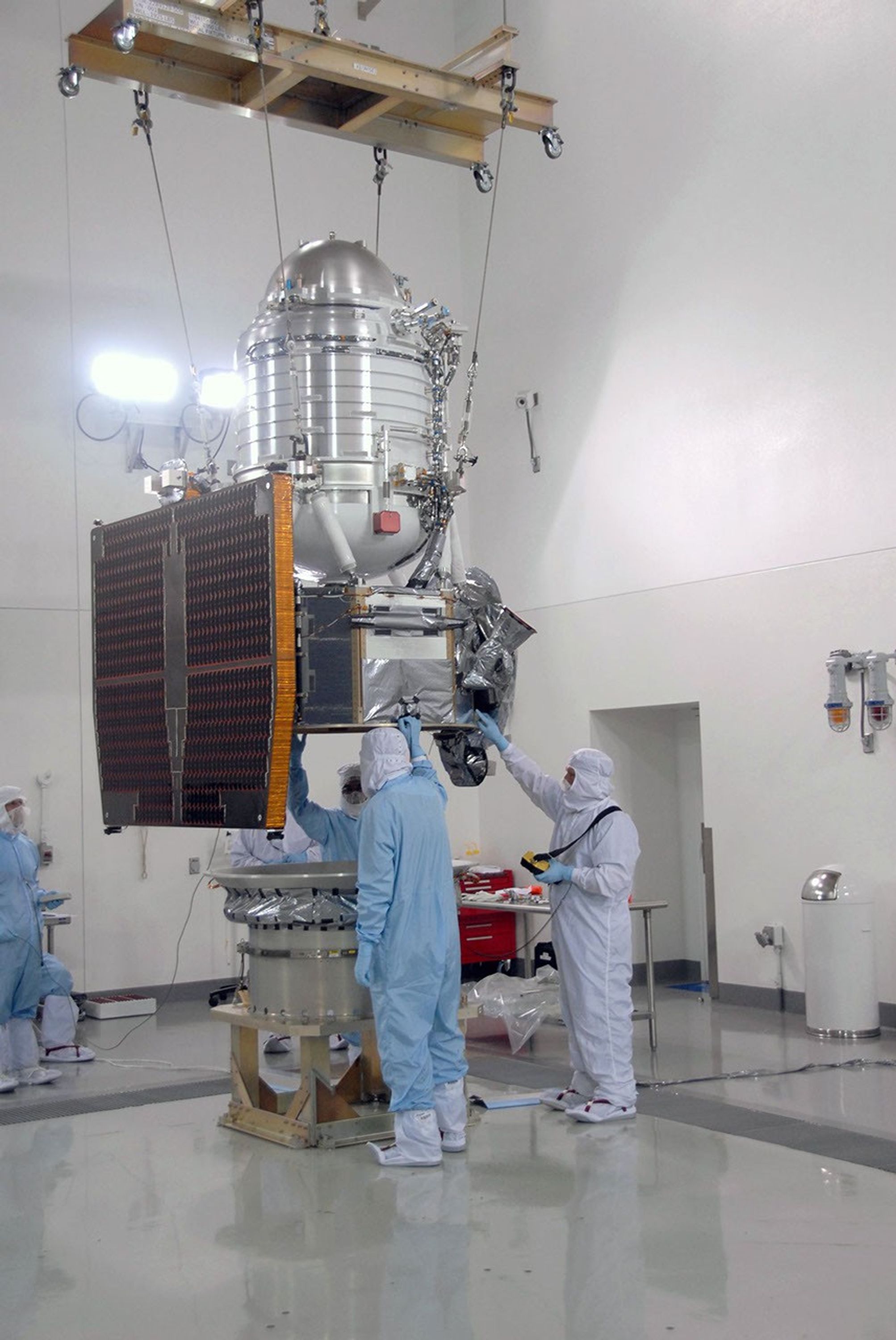 At Vandenberg Air Force Base's Astrotech processing facility in California, NASA's Wide-field Infrared Survey Explorer, or WISE, spacecraft is lowered toward the flight conical adapter and test stand.