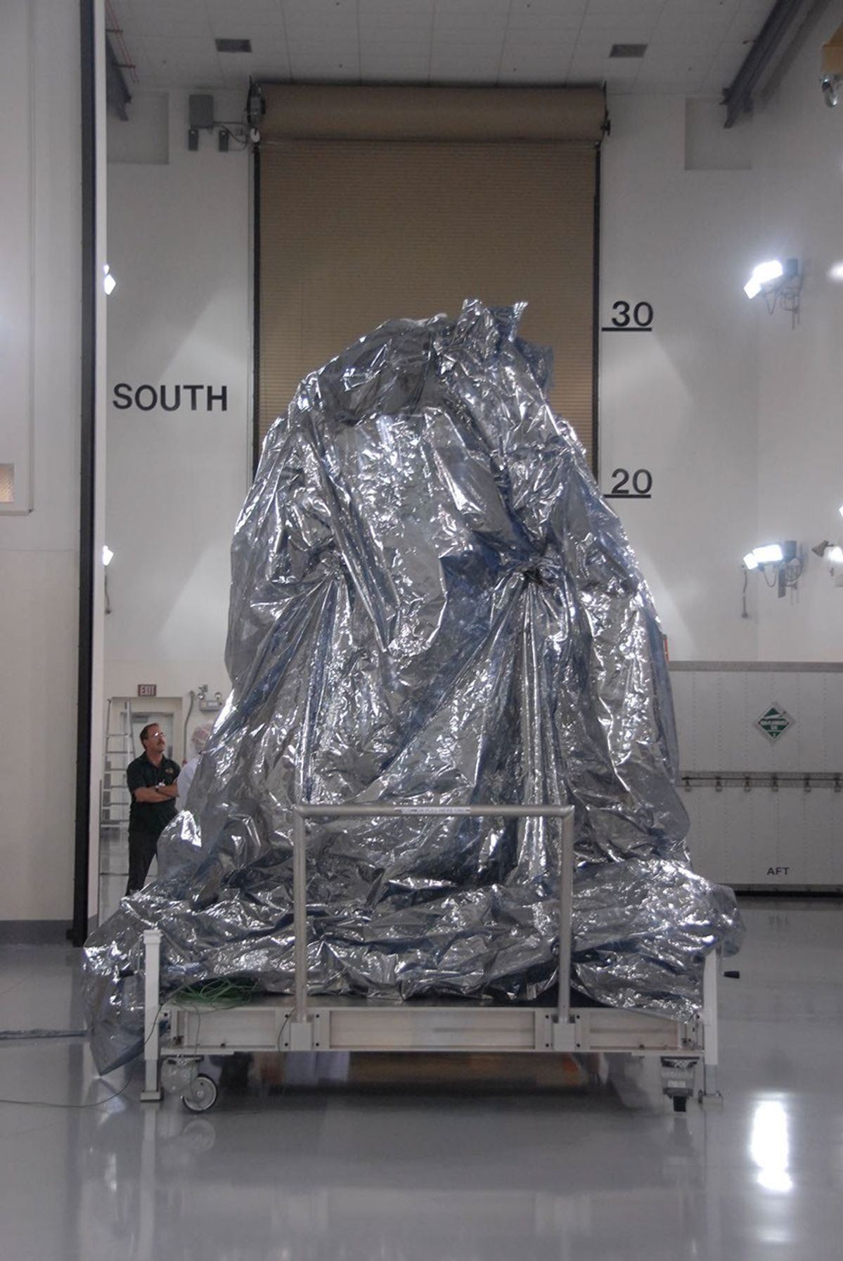 NASA's Wide-field Infrared Survey Explorer spacecraft sits with its protective covering.