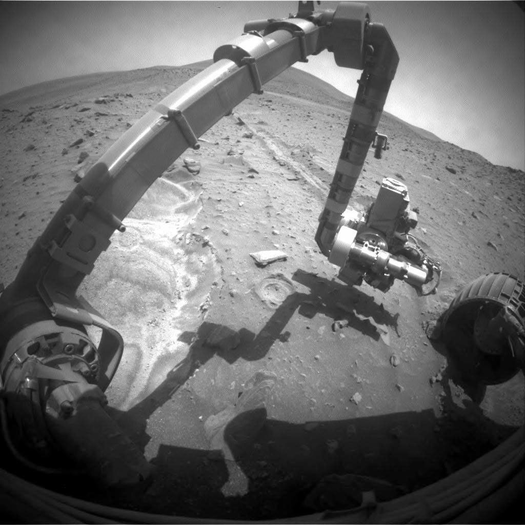 NASA's Mars Exploration Rover Spirit recorded this forward view of its arm and surroundings; bright soil in the left half of the image is loose, fluffy material churned by the rover's left-front wheel as Spirit.
