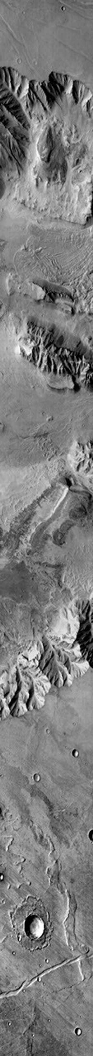 This image from NASA's Mars Odyssey shows Coprates Chasma, part of Valles Marineris on Mars. There is a large landslide deposit in the northern part of the chasma.