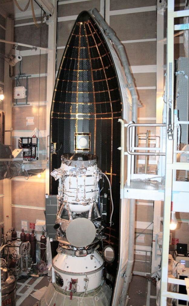 NASA's Wide-field Infrared Survey Explorer is shown inside one-half of the nose cone, or fairing, that will protect it during launch.