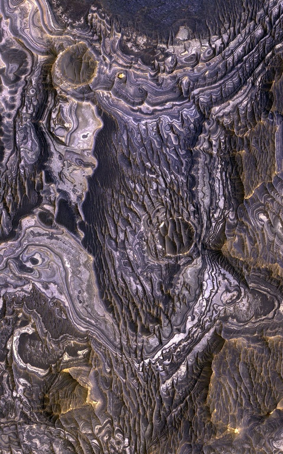 This view, taken by NASA's Mars Reconnaissance Orbiter, shows color variations in bright layered deposits on a plateau near Juventae Chasma in the Valles Marineris region of Mars.