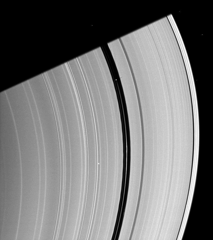 Saturn's moon Pan, orbiting in the Encke Gap near the top of the image, casts a short shadow on the A ring in this image taken by NASA's Cassini spacecraft about six months after the planet's August 2009 equinox.
