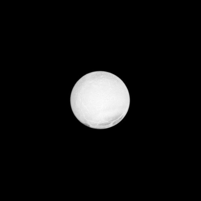 The highly reflective surface of Saturn's moon Enceladus is almost completely illuminated in this NASA Cassini spacecraft image taken at a low phase angle.
