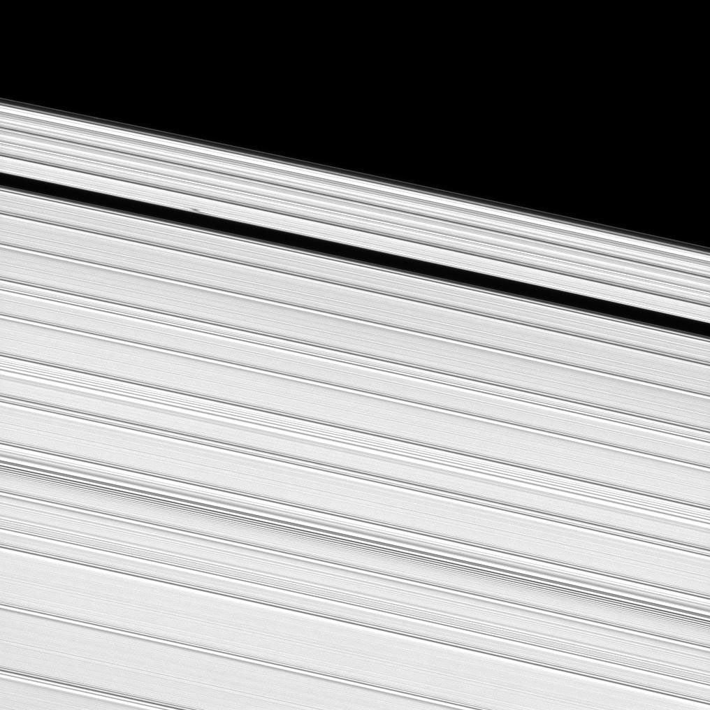 A propeller-shaped structure, created by an unseen moon, can be seen in Saturn's A ring and looks like a small, dark line interrupting the bright surrounding ring material in the upper left of this image taken by NASA's Cassini spacecraft.