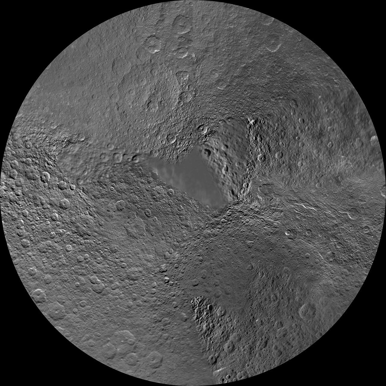 The northern hemisphere of Saturn's moon Rhea is seen in this polar stereographic map, mosaicked from the best-available images obtained by NASA's Cassini and Voyager spacecraft.