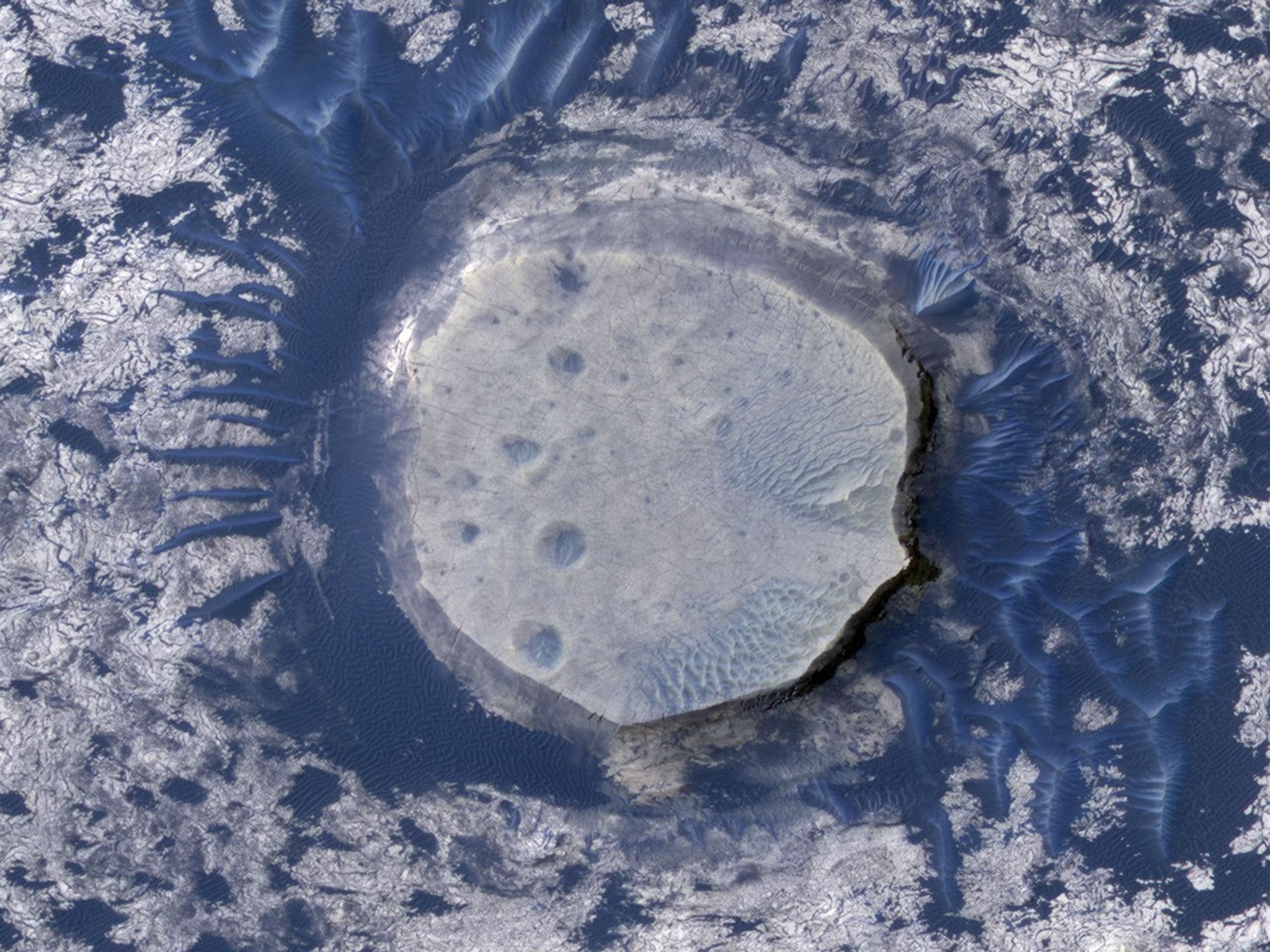 This view of an inverted crater in the Arabia Terra region of Mars is among the images taken by NASA's Mars Reconnaissance Orbiter in early 2010 as the spacecraft approached the 100-terabit milestone in total data returned.