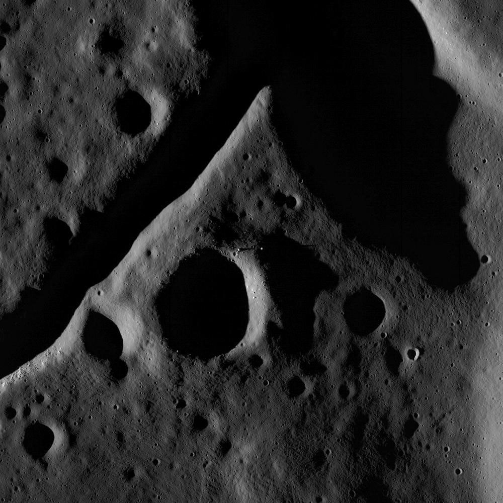 The central peak and fractured floor of Compton crater as imaged by the LROC Narrow Angle Camera onboard NASA's Lunar Reconnaissance Orbiter at dusk, image width is ~1720 meters.