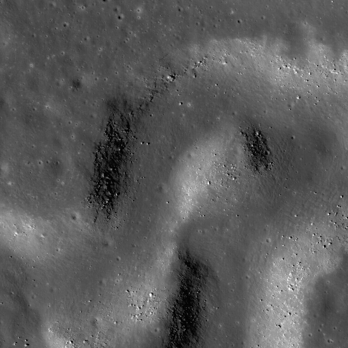 NASA's Lunar Reconnaissance Orbiter's shows a sinuous rille winding its way across a much larger rille in the heart of the Aristarchus Plateau.