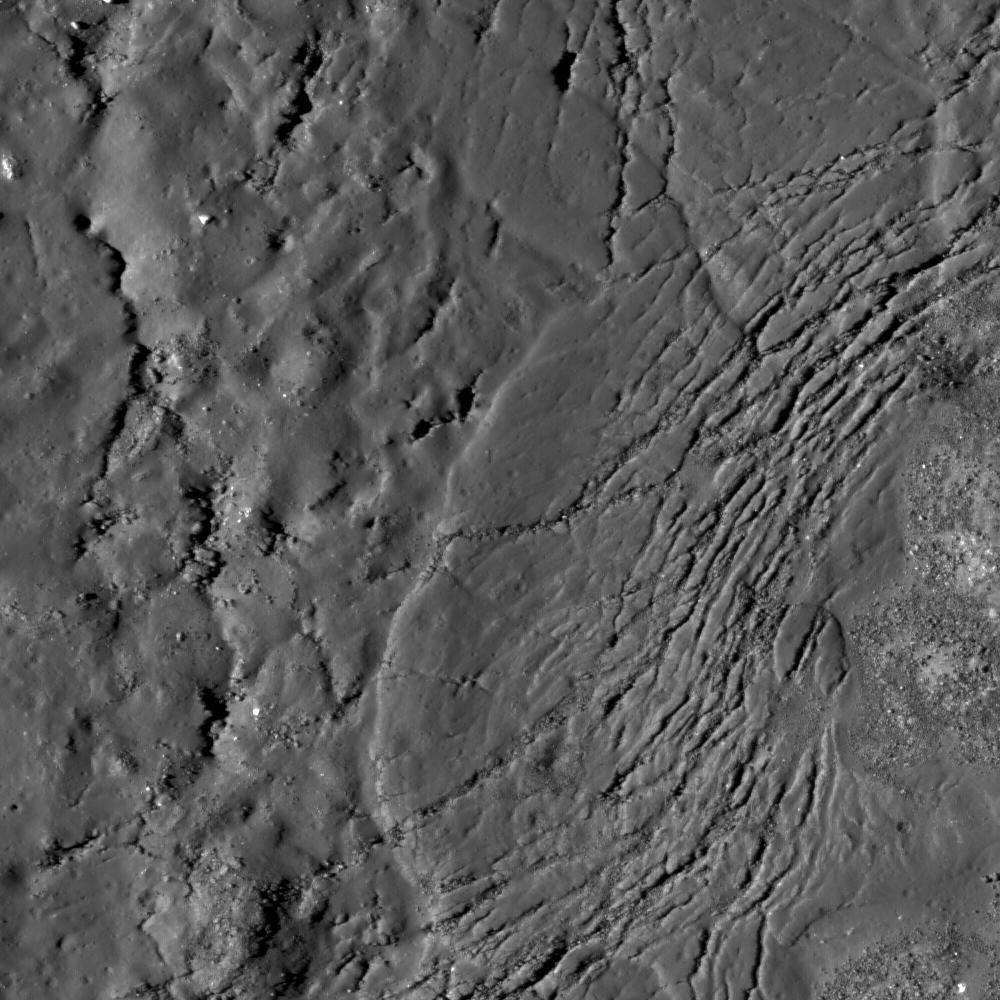 Cracks form in the impact melt sheet on the floor of Necho Crater in this image taken by NASA's Lunar Reconnaissance Orbiter.