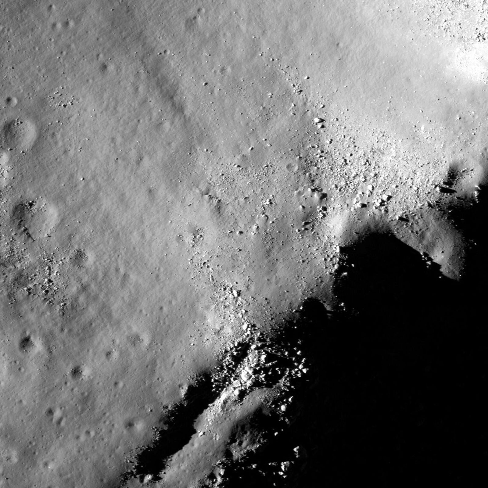 Boulders perched on the summit of the central peak of Tsiolkovskiy crater are seen in this image from NASA's Lunar Reconnaissance Orbiter.