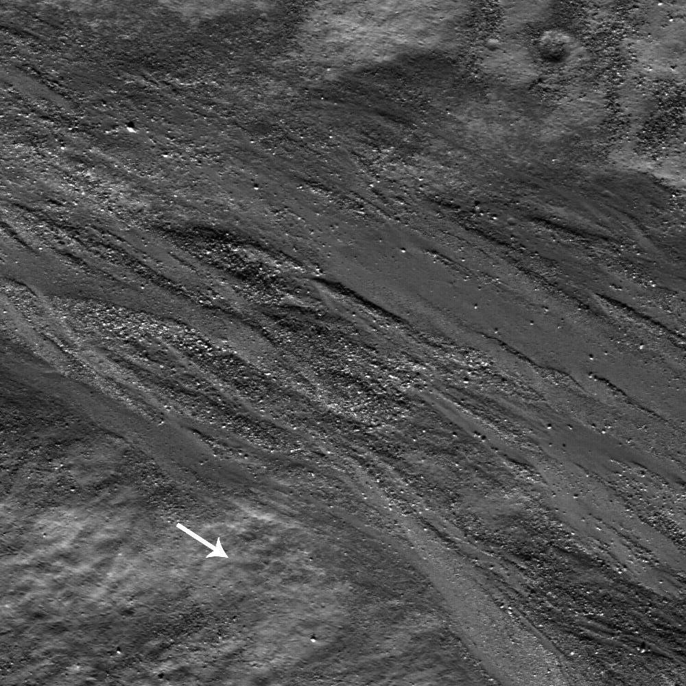 High-albedo marks on the lunar surface left by a boulder bouncing down the northeast wall of farside highlands crater Moore F in this image captured by NASA's Lunar Reconnaissance Orbiter.