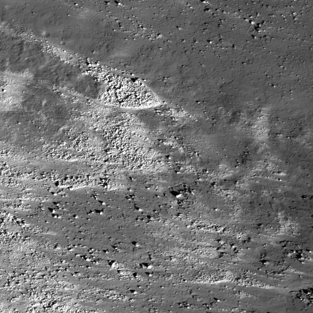 This image taken by NASA's Lunar Reconnaissance Orbiter shows the slopes of the Vallis SchrÃ¶teri, 'Cobra Head' are boulder-rich and display albedo variations -- bright to dark.