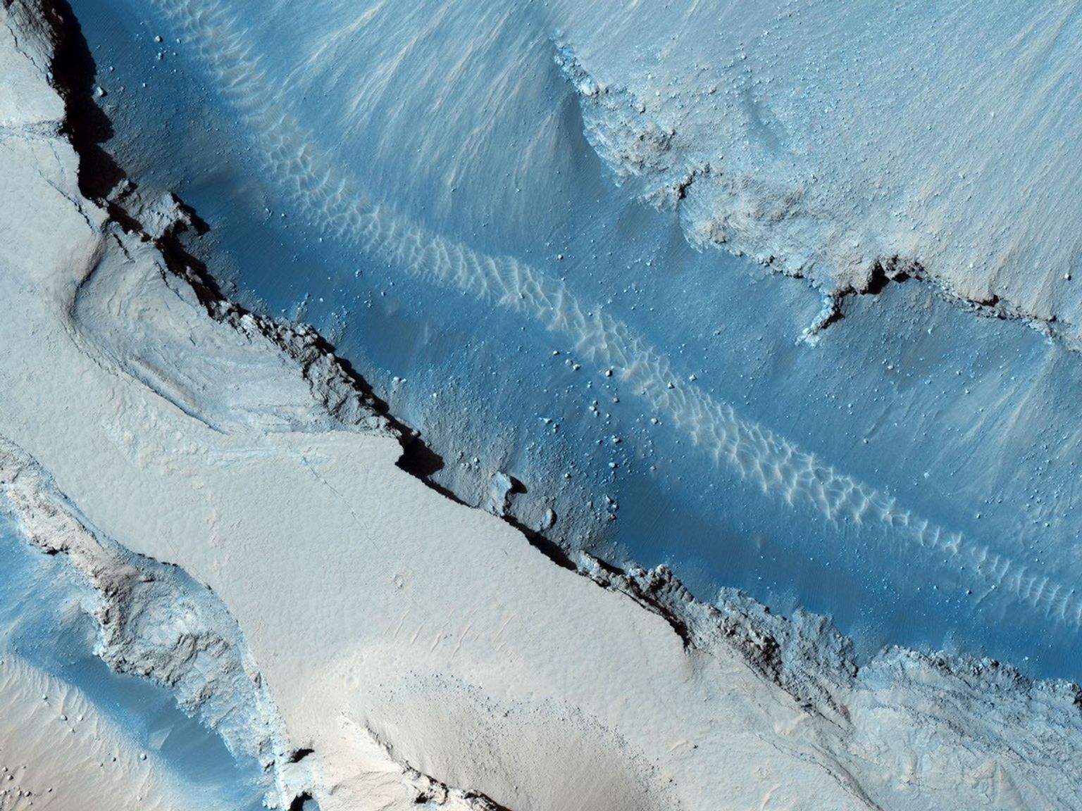 This image taken by NASA's Mars Reconnaissance Orbiter shows part of Cerberus Fossae, a long system of extensional (normal) faults arranged in trough-bounding (graben-bounding) pairs.