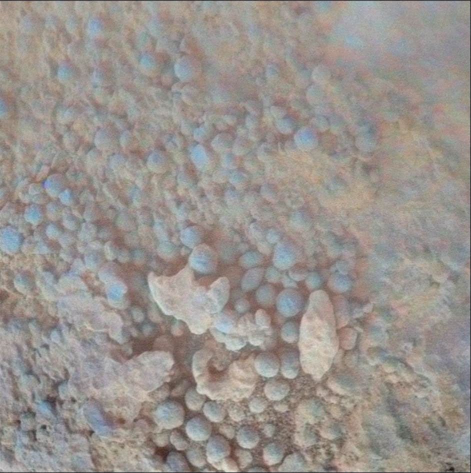 This image from the microscopic imager on NASA's Mars Exploration Rover Opportunity shows details of the coating on a rock called 'Chocolate Hills,' which the rover found and examined at the edge of a young crater called 'Concepción.'
