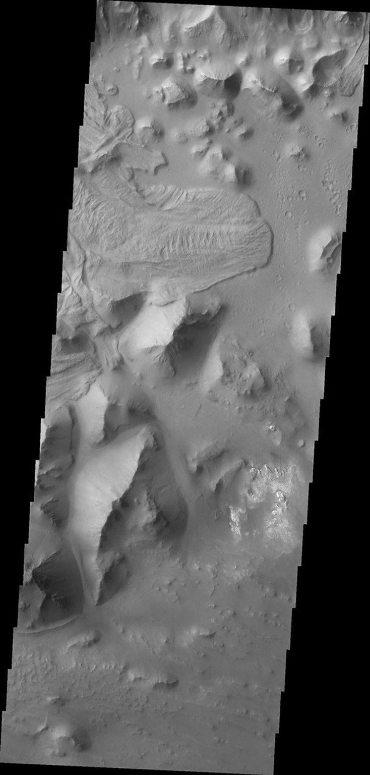 The landslide deposit in this image captured by NASA's 2001 Mars Odyssey spacecraft is located in Aurorae Chaos (distinctive area of broken terrain). Several regions of chaotic terrain are located on the eastern end of the Valles Marineris system.