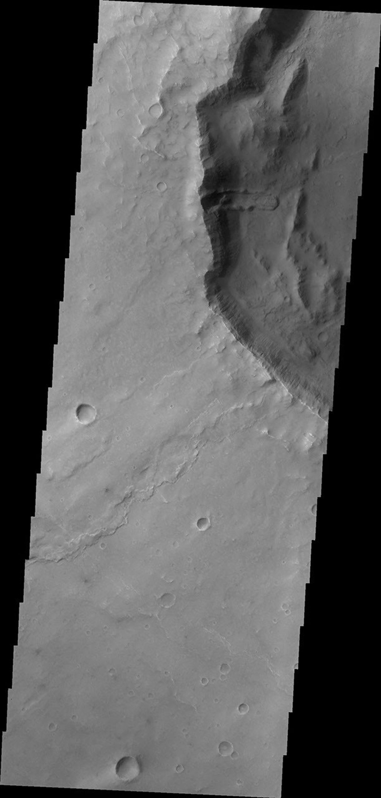 This image captured by NASA's 2001 Mars Odyssey shows a landslide deposit located in an unnamed crater in Syrtis Planum.