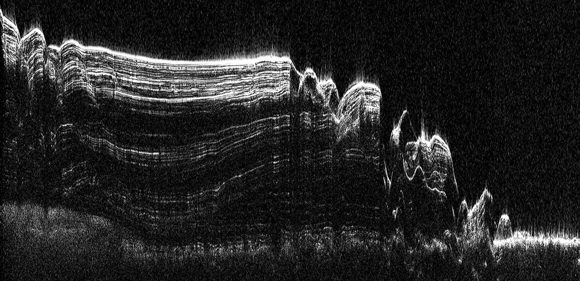 This image shows a cross-section of a portion of the north polar ice cap of Mars, derived from data acquired from NASA's Mars Reconnaissance Orbiter's Shallow Radar instrument. The data depict the region's internal ice structure.