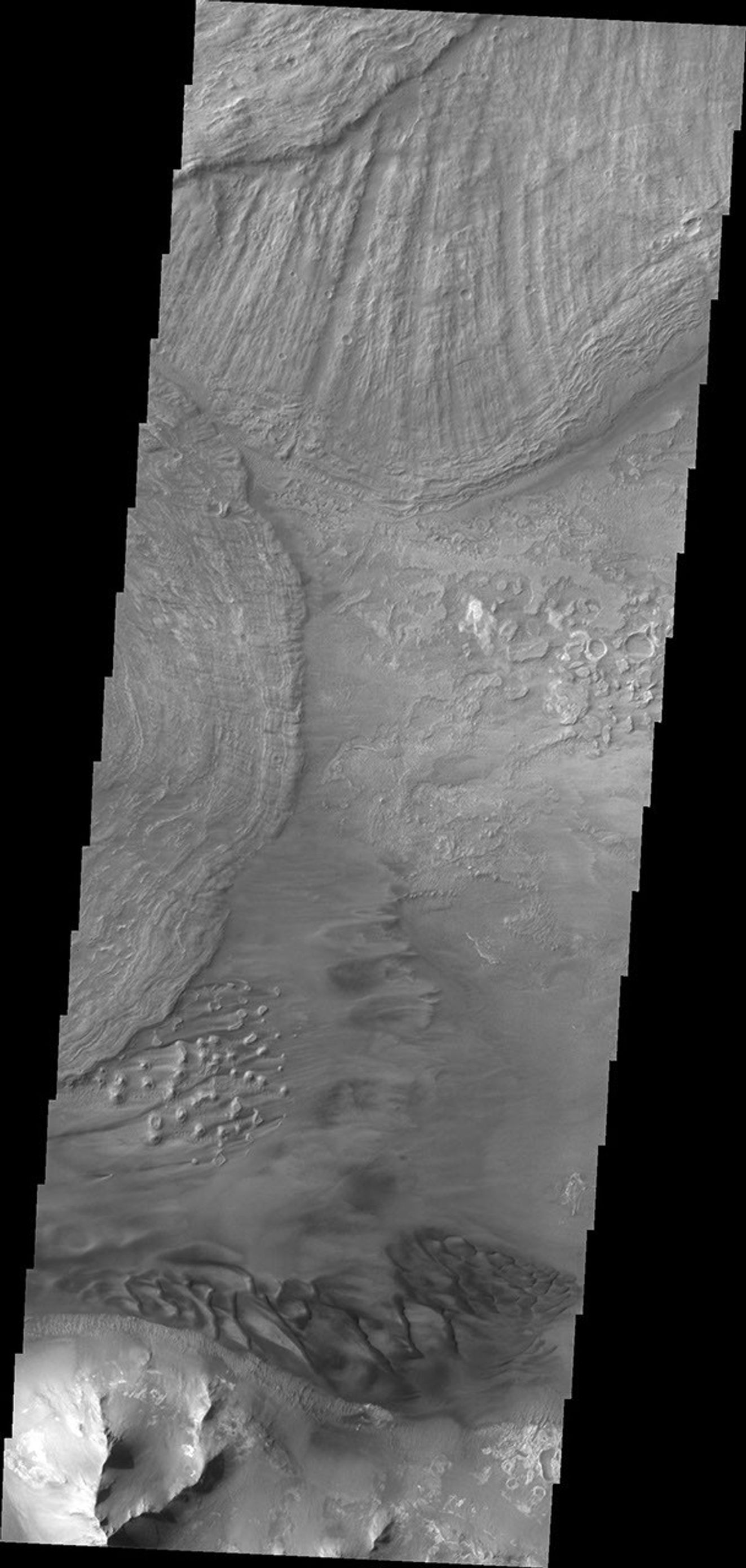Large landslide deposits dominate this image of Ius Chasma captured by NASA's 2001 Mars Odyssey. Dunes are visible at the bottom of the frame.