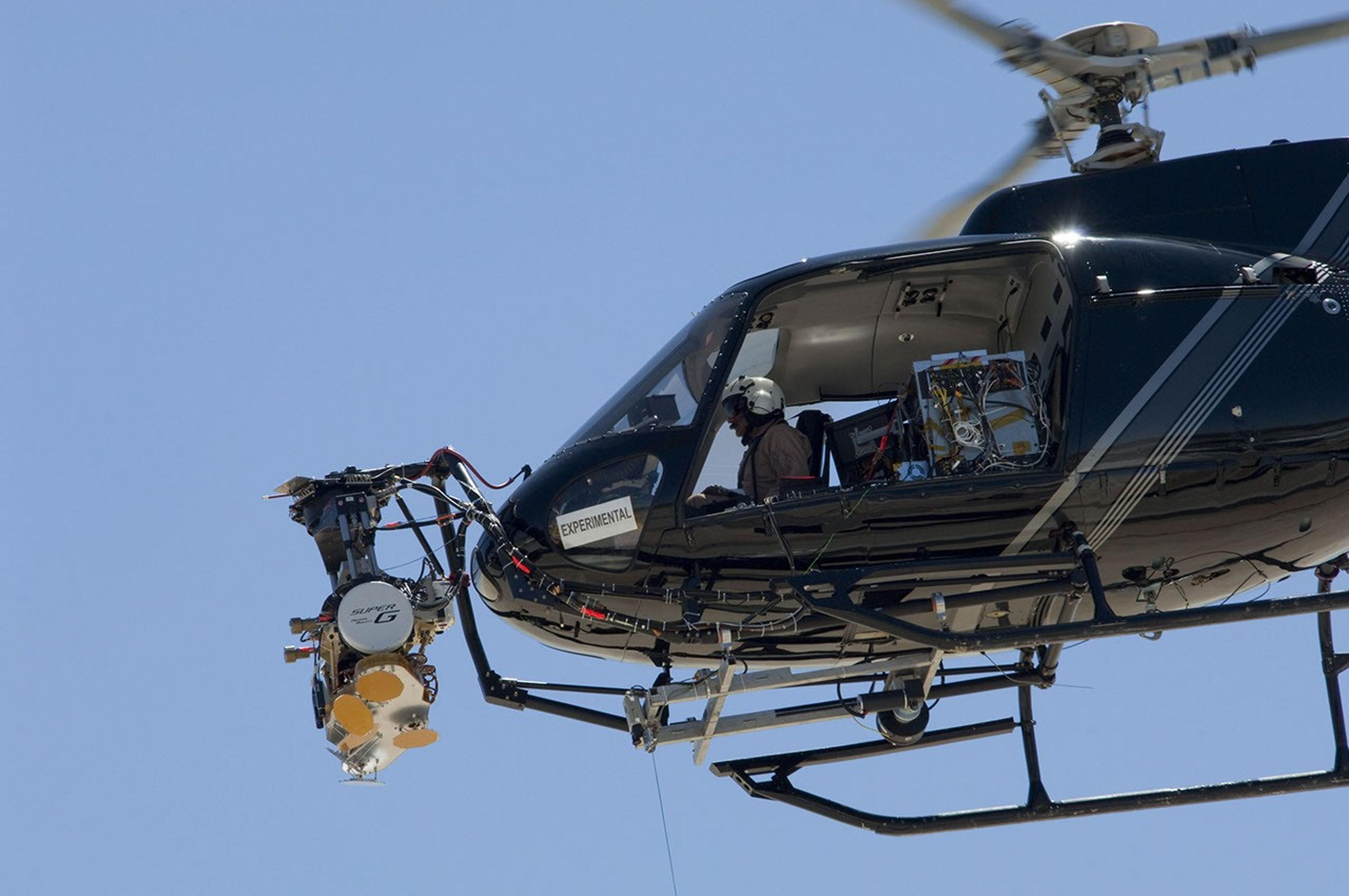 The engineering test model for the radar system that will be used during the next landing on Mars is shown here mounted onto a helicopter's nose gimbal during a May 12, 2010, test at NASA's Dryden Flight Research Center, Edwards, Calif.