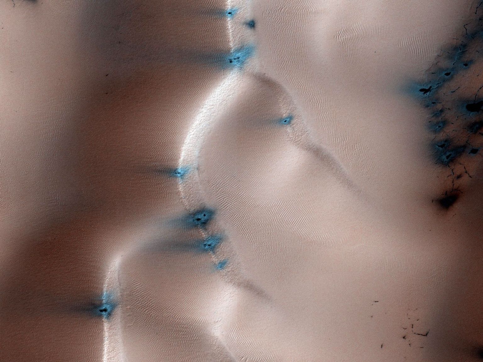 This image from NASA's Mars Reconnaissance Orbiter is a view of the sand dune field in Richardson Crater covered with seasonal frost. The frost is a combination of frozen carbon dioxide and some water ice that covers the dunes in the winter and spring.