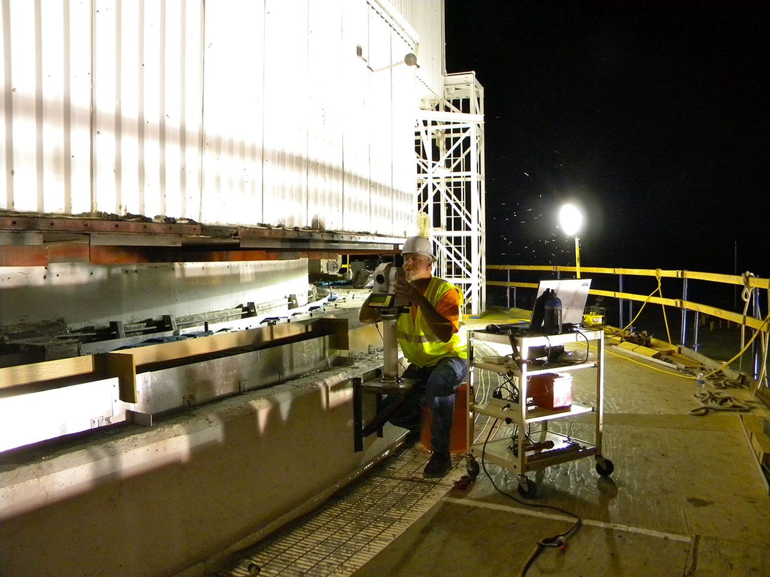 An engineer at NASA's Jet Propulsion Laboratory in Pasadena, Calif., checks the evenness of sole plates installed on the giant 'Mars antenna' at NASA's Deep Space Network communications site in Goldstone, Calif.