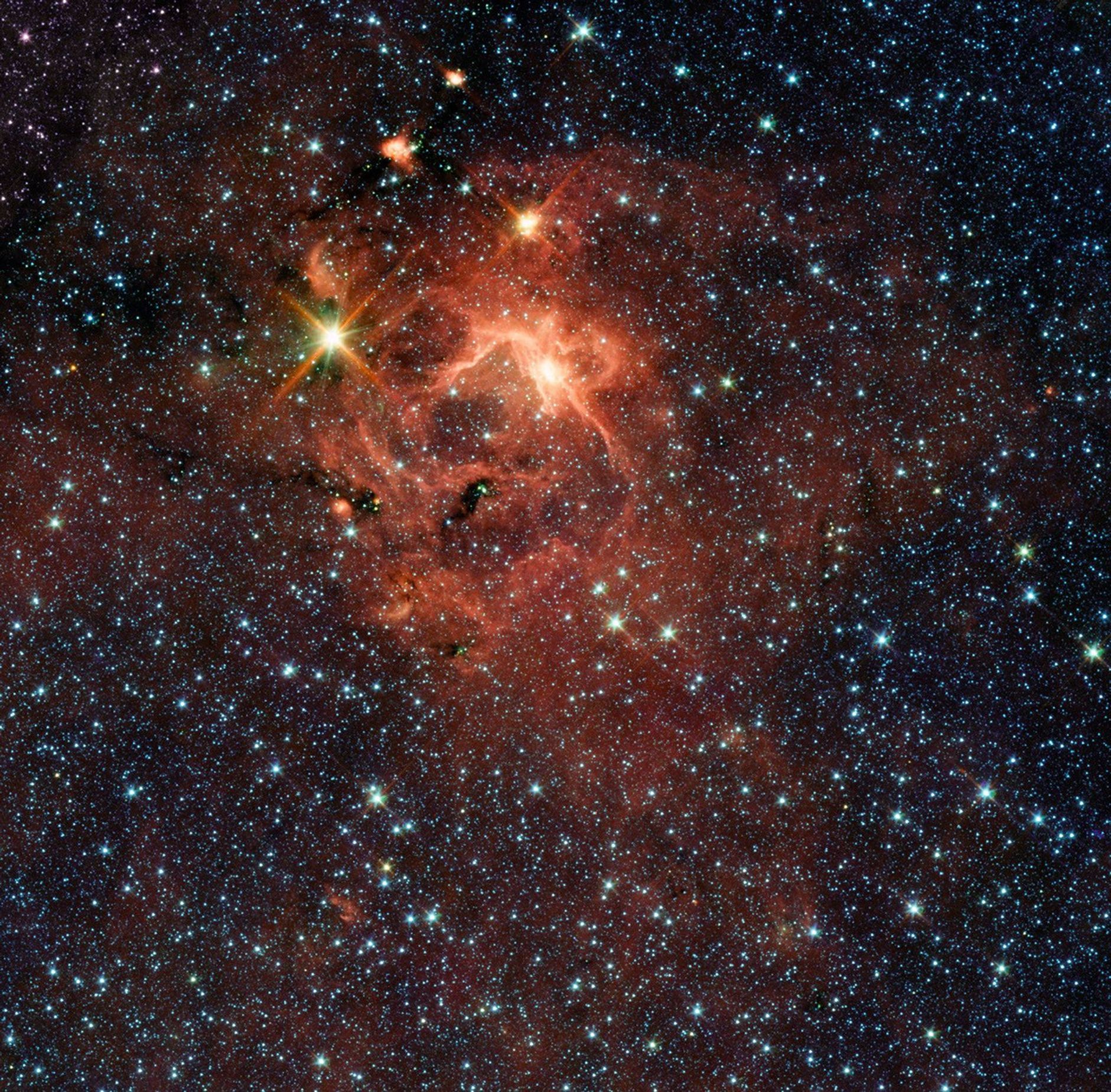 This star-forming region, captured by NASA's Spitzer Space Telescope, is dominated by the bright, young star IRAS 13481-6124; it is the first massive baby star for which astronomers could obtain a detailed look at the dusty disk closely encircling it.