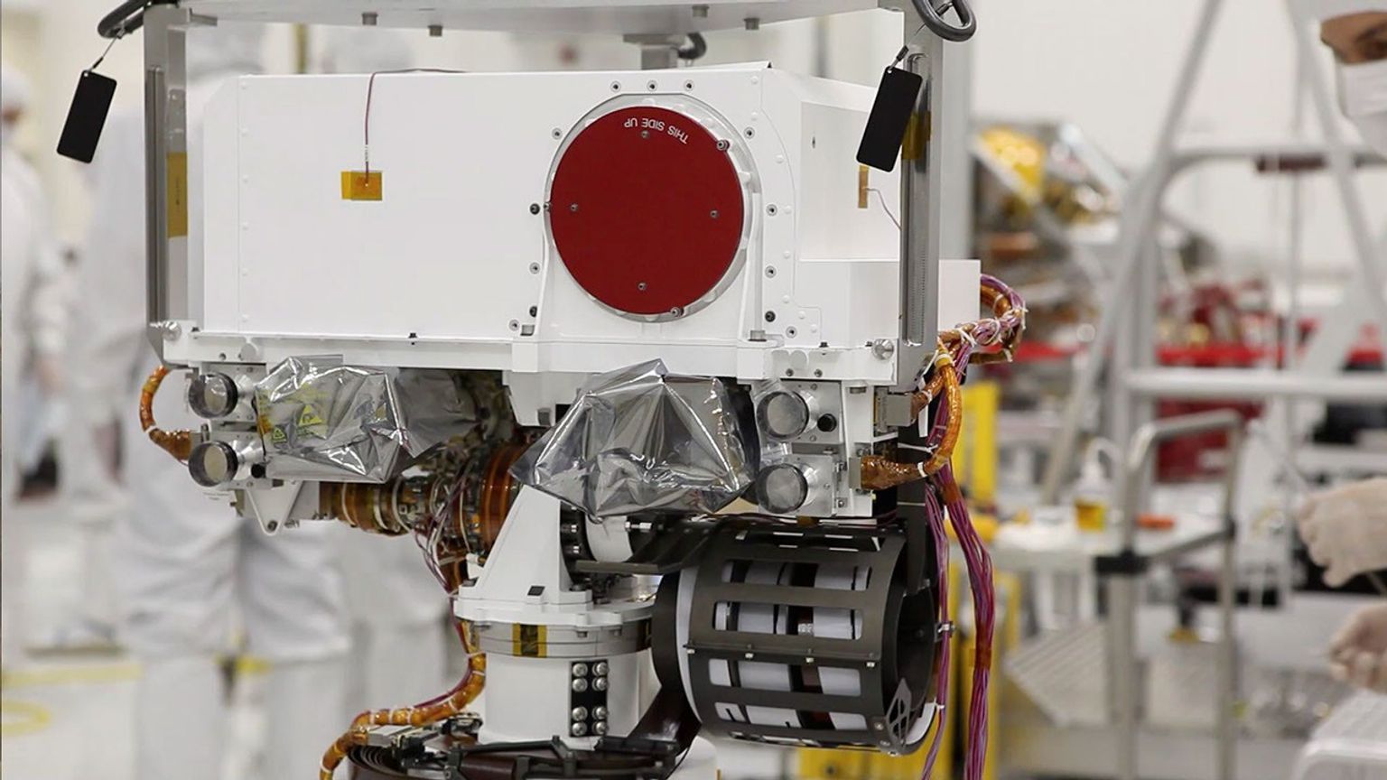 Curiosity's 'eyes' (the Mastcam) are shrouded in a silvery material, awaiting their first look around the clean room at NASA's Jet Propulsion Laboratory, where the rover is being built.