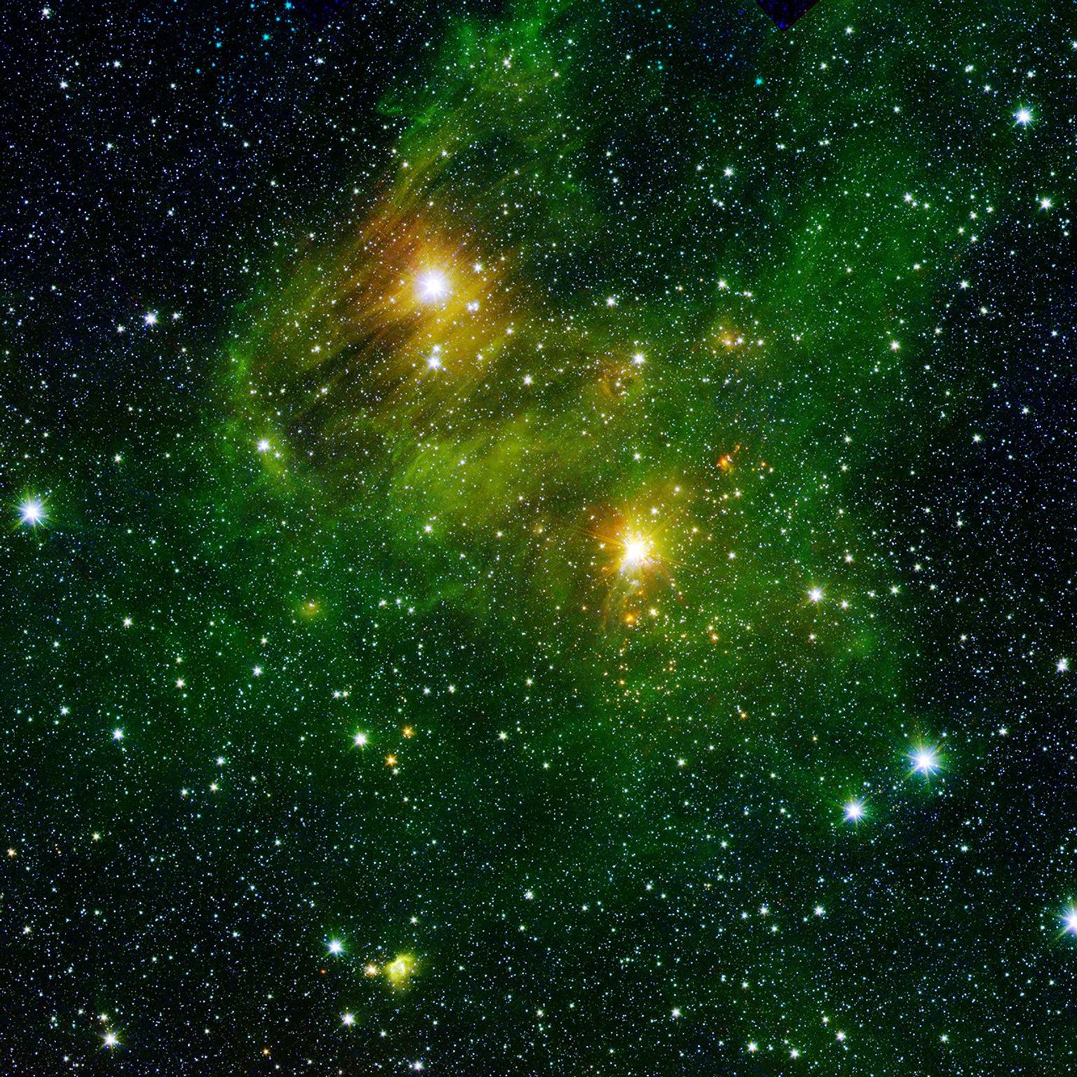 Two extremely bright stars illuminate a greenish mist in this image from the new 'GLIMPSE360' survey from NASA's Spitzer Space Telescope. The fog is comprised of hydrogen and carbon compounds called polycyclic aromatic hydrocarbons.