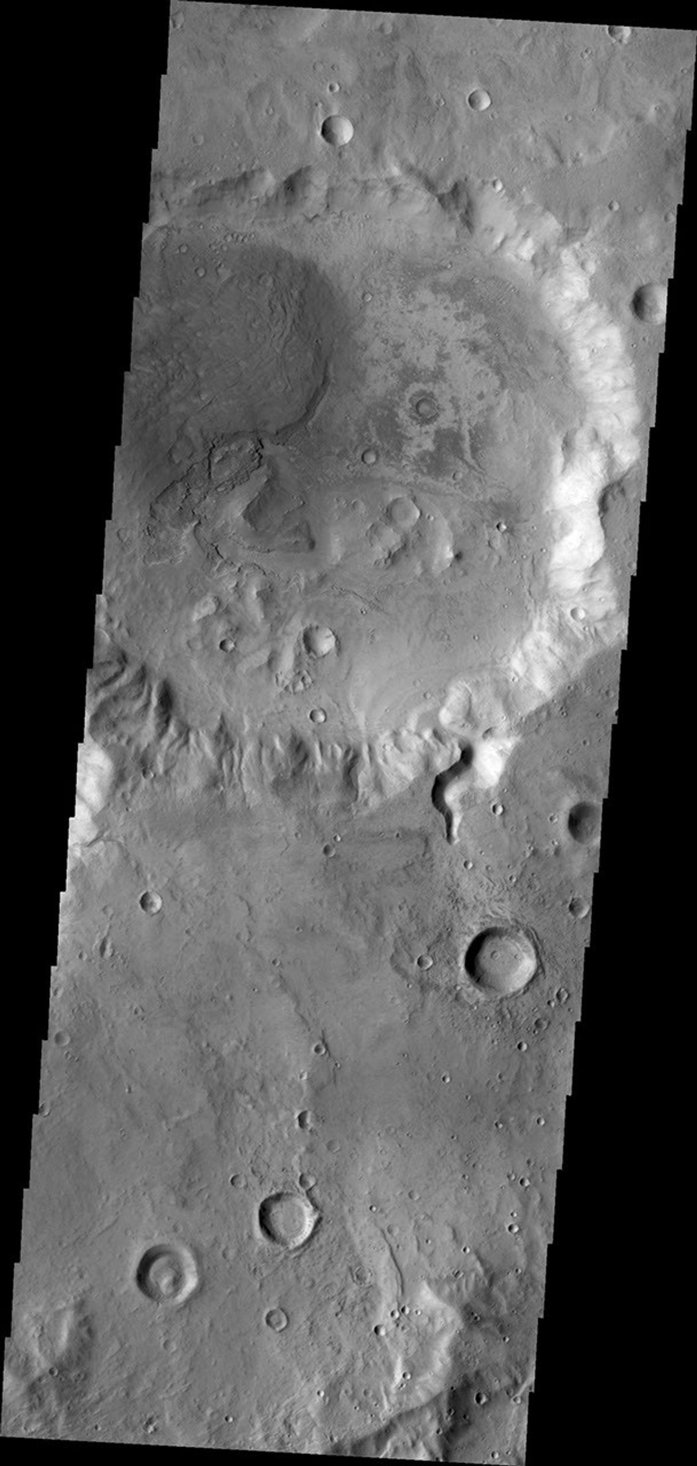 A small channel enters this unnamed crater in Arabia Terra. There appears to be a small fan or delta formed where the channel meets the crater floor. This image was captured by NASA's Mars Odyssey on June 15, 2010.