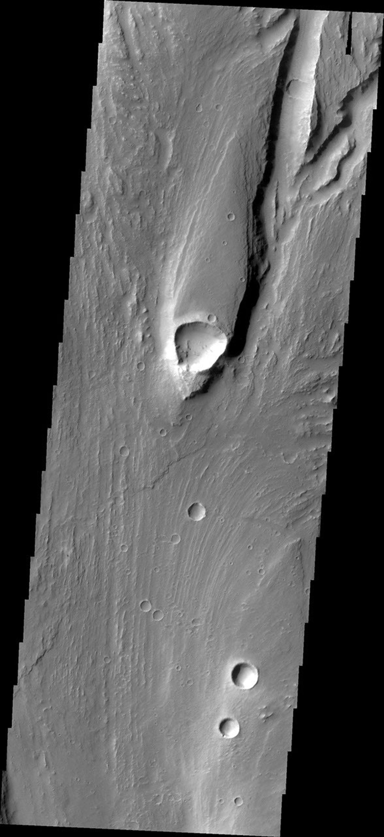 This streamlined island is located within Maja Valles was captured by NASA's Mars Odyssey on July 1, 2010.