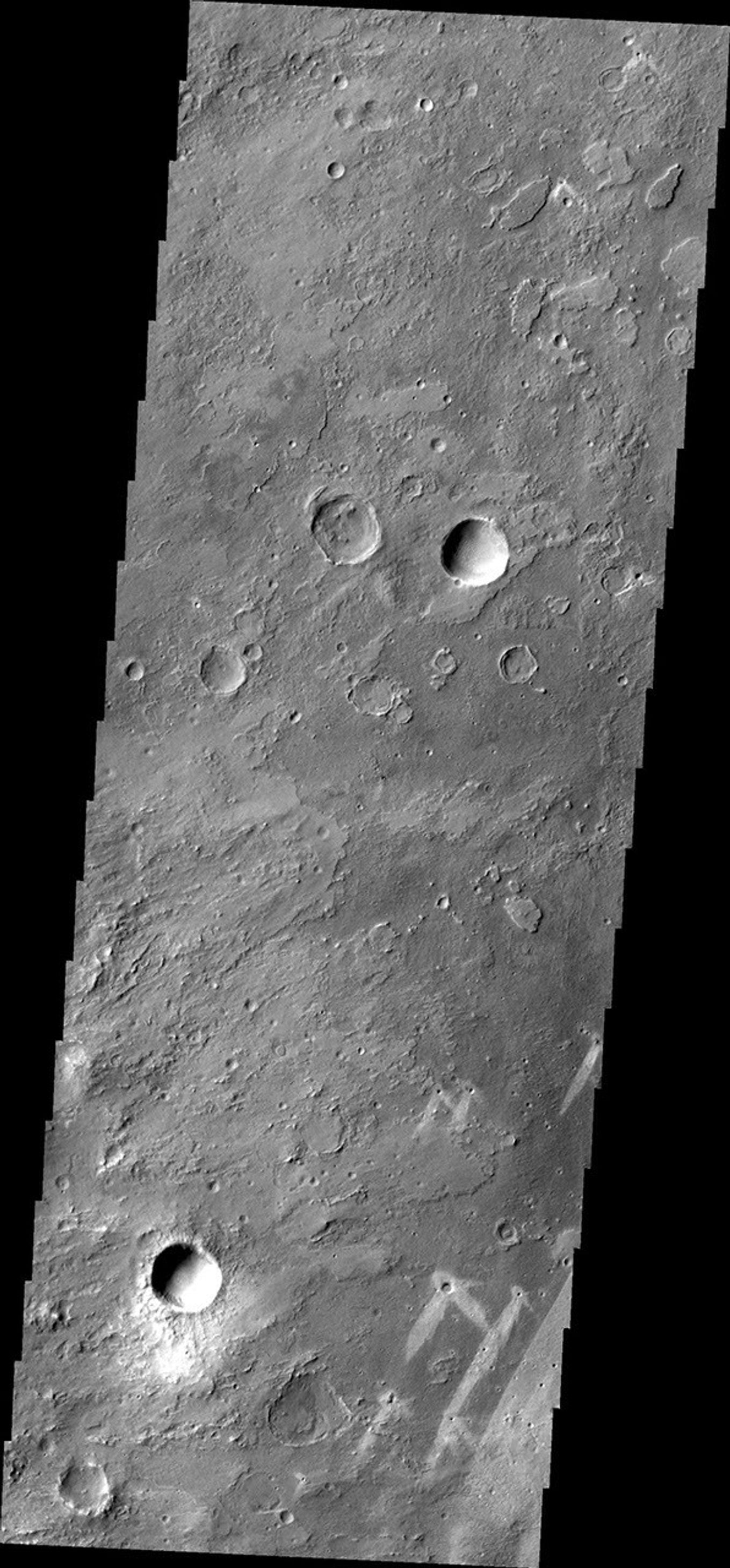 This image from NASA's Mars Odyssey of part of Meridiani Planum contains windstreaks that formed in several directions around a single crater. This indicates that wind directions changed, forming new tails for each prevailing wind direction.