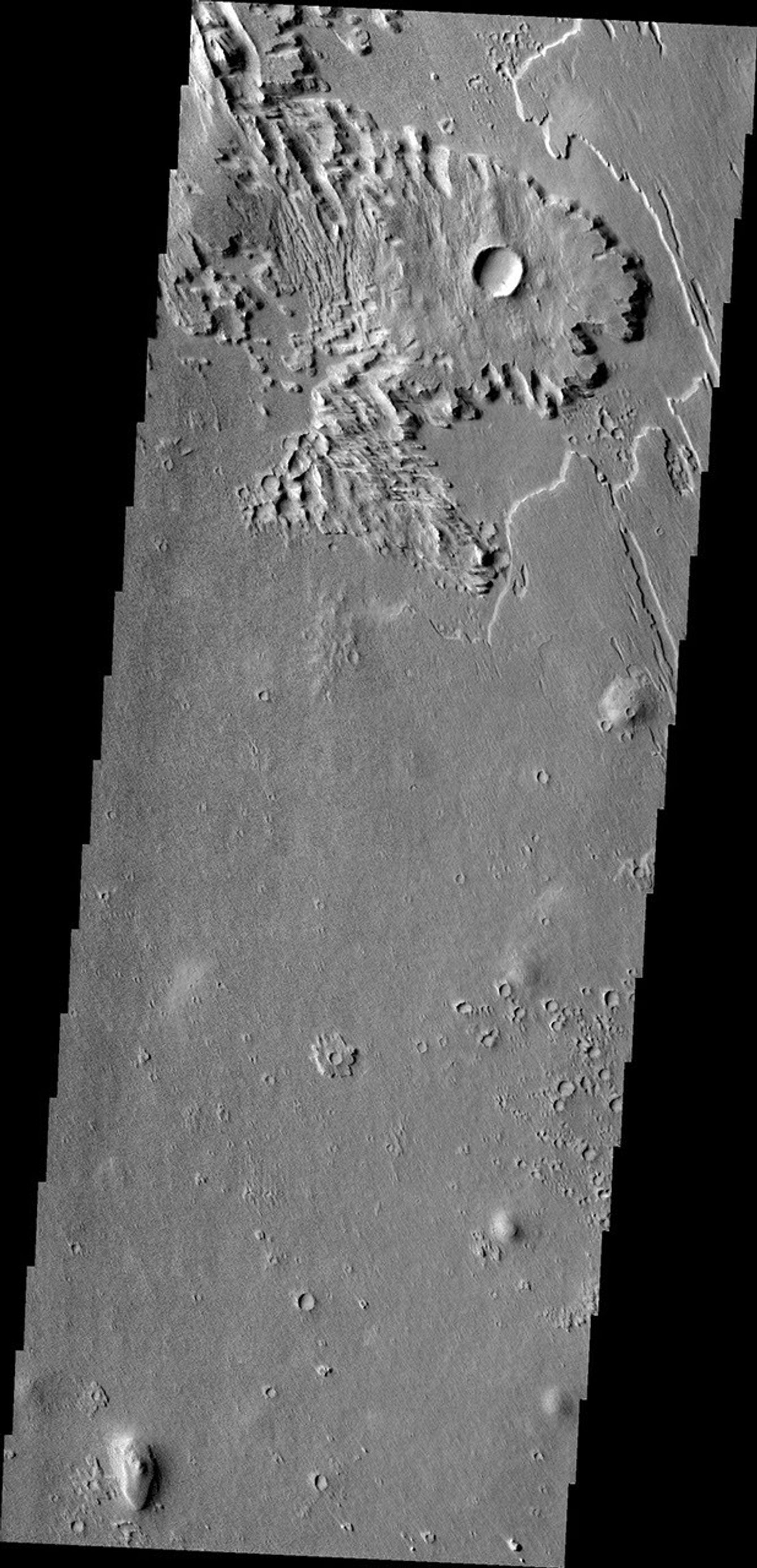 This wind eroded crater is located between Eumenides and Gordii Dorsa. The ejecta of the crater is more resistant to the wind than the surrounding materials in this image from NASA's Mars Odyssey.