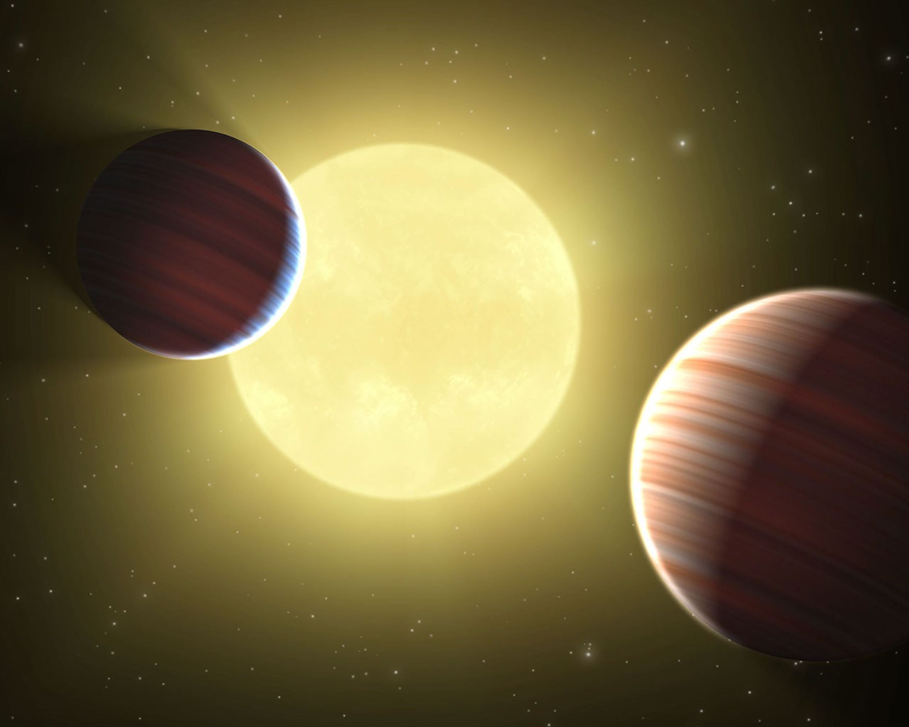 This artist's concept illustrates the two Saturn-sized planets discovered by NASA's Kepler mission. The star system is oriented edge-on, as seen by Kepler, such that both planets cross in front, or transit, their star, named Kepler-9.
