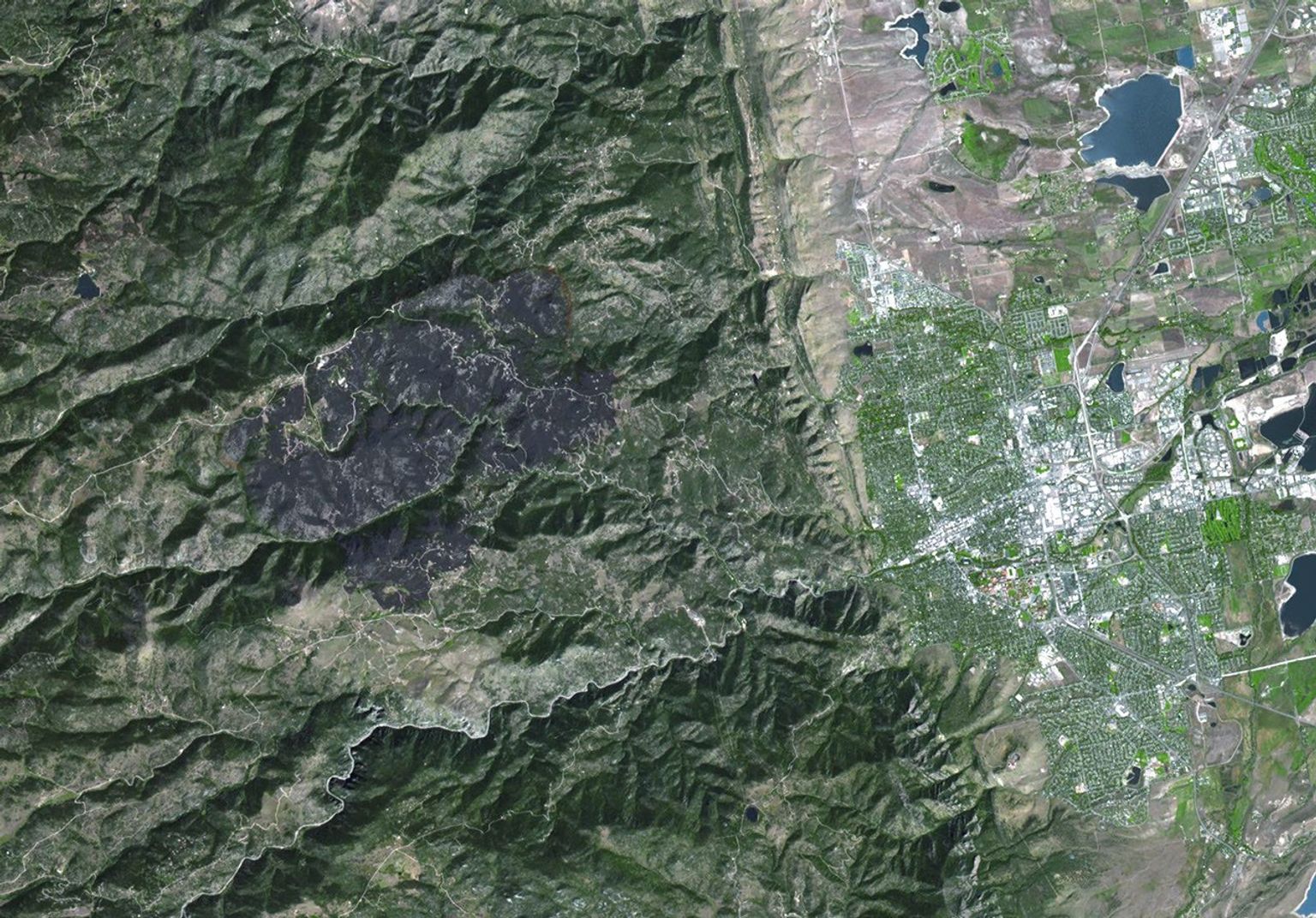 The Advanced Spaceborne Thermal Emission and Reflection Radiometer (ASTER) instrument aboard NASA's Terra spacecraft captured this image of the Fourmile Canyon fire west of Boulder Colo., on Sept. 17, 2010; it was 100 percent contained.