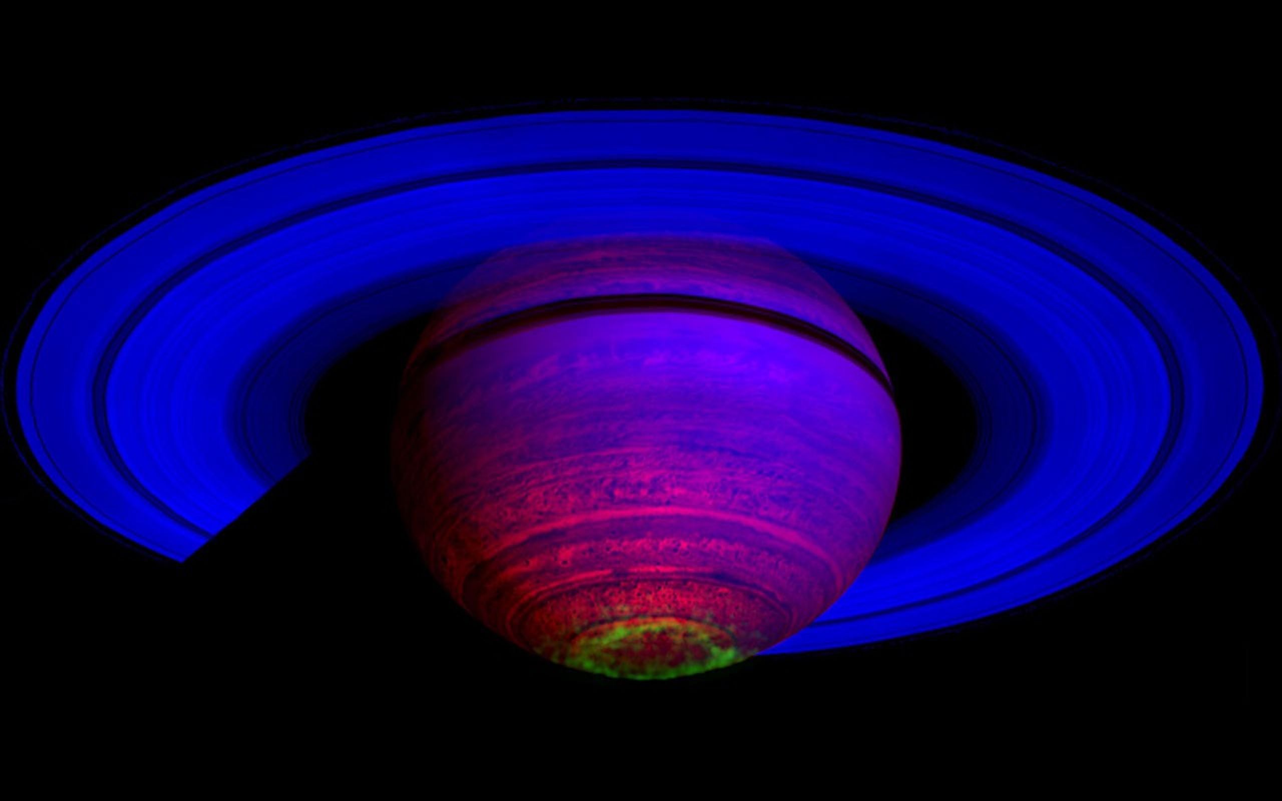 This false-color composite image, constructed from data obtained by NASA's Cassini spacecraft, shows the glow of auroras streaking out about 1,000 kilometers (600 miles) from the cloud tops of Saturn's south polar region.