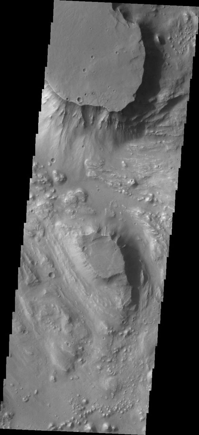 Located at the eastern end of Vallis Marineris is the region of chaos called Aurorae. This image from NASA's Mars Odyssey is from the northern part of Aurorae Chaos and contains mesas separated by complex low lying regions.