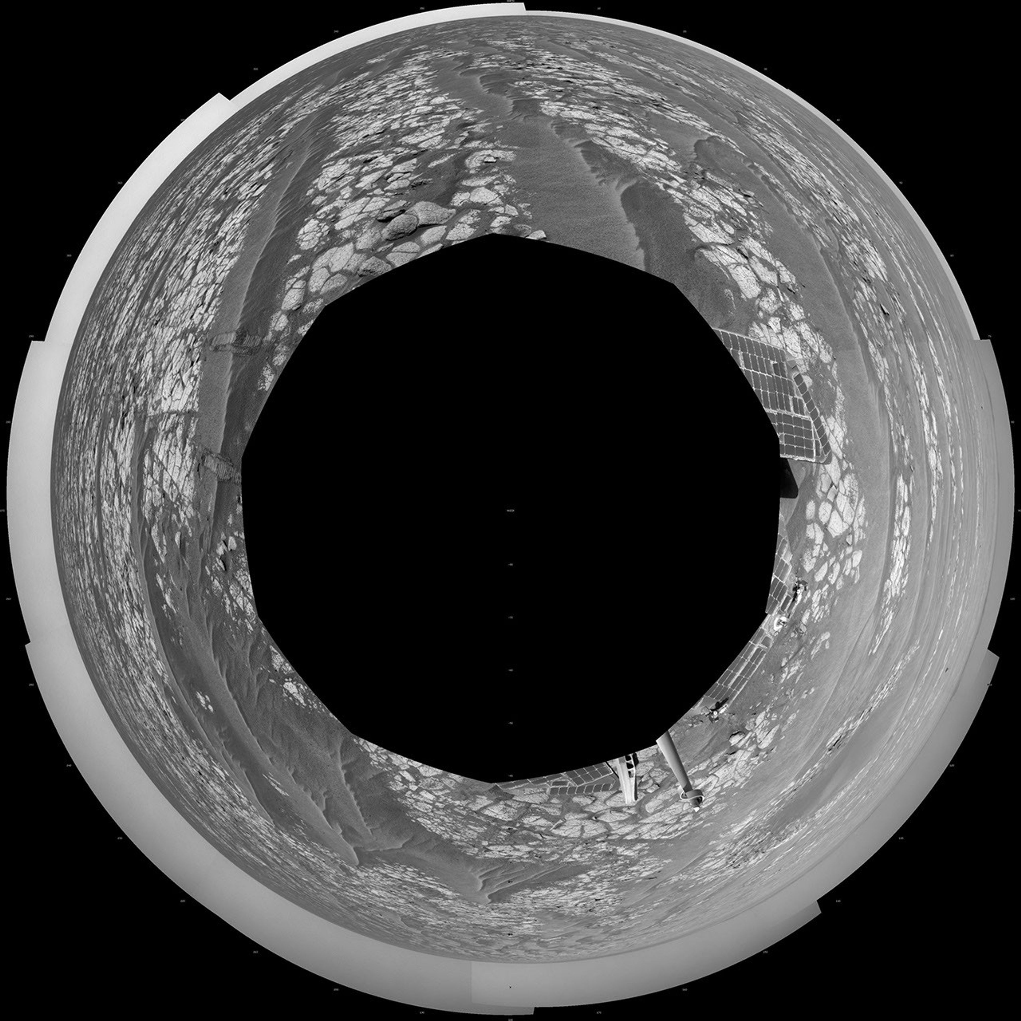 This mosaic of images from NASA's Mars Exploration Rover Opportunity shows surroundings of the rover's location on Sept. 16, 2010. The terrain includes light-toned bedrock and darker ripples of wind-blown sand.