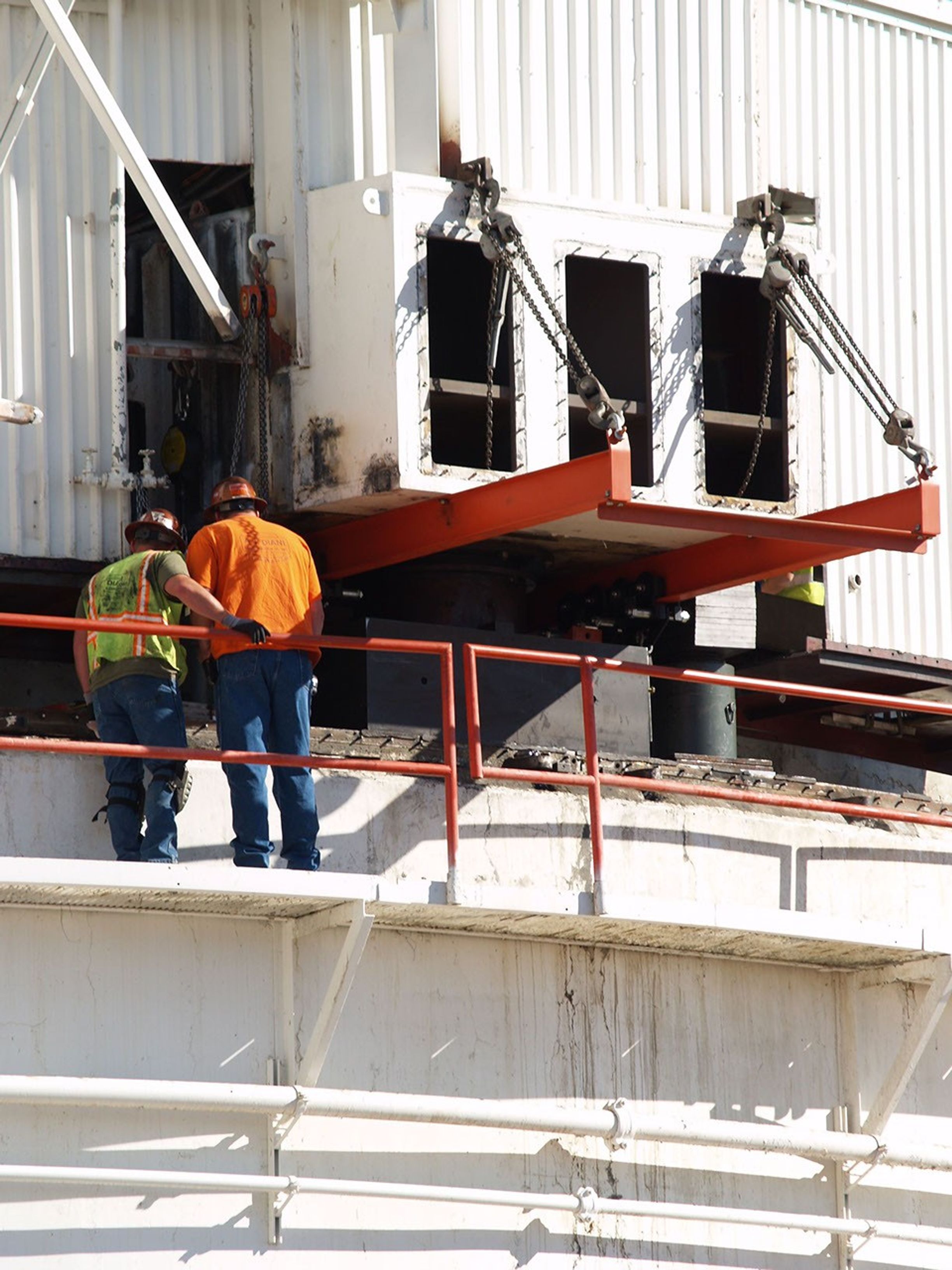 Workers at NASA's Deep Space Network's Goldstone Deep Space Communications Complex check on a set of jacks used to raise the upper part of the giant 'Mars antenna.'