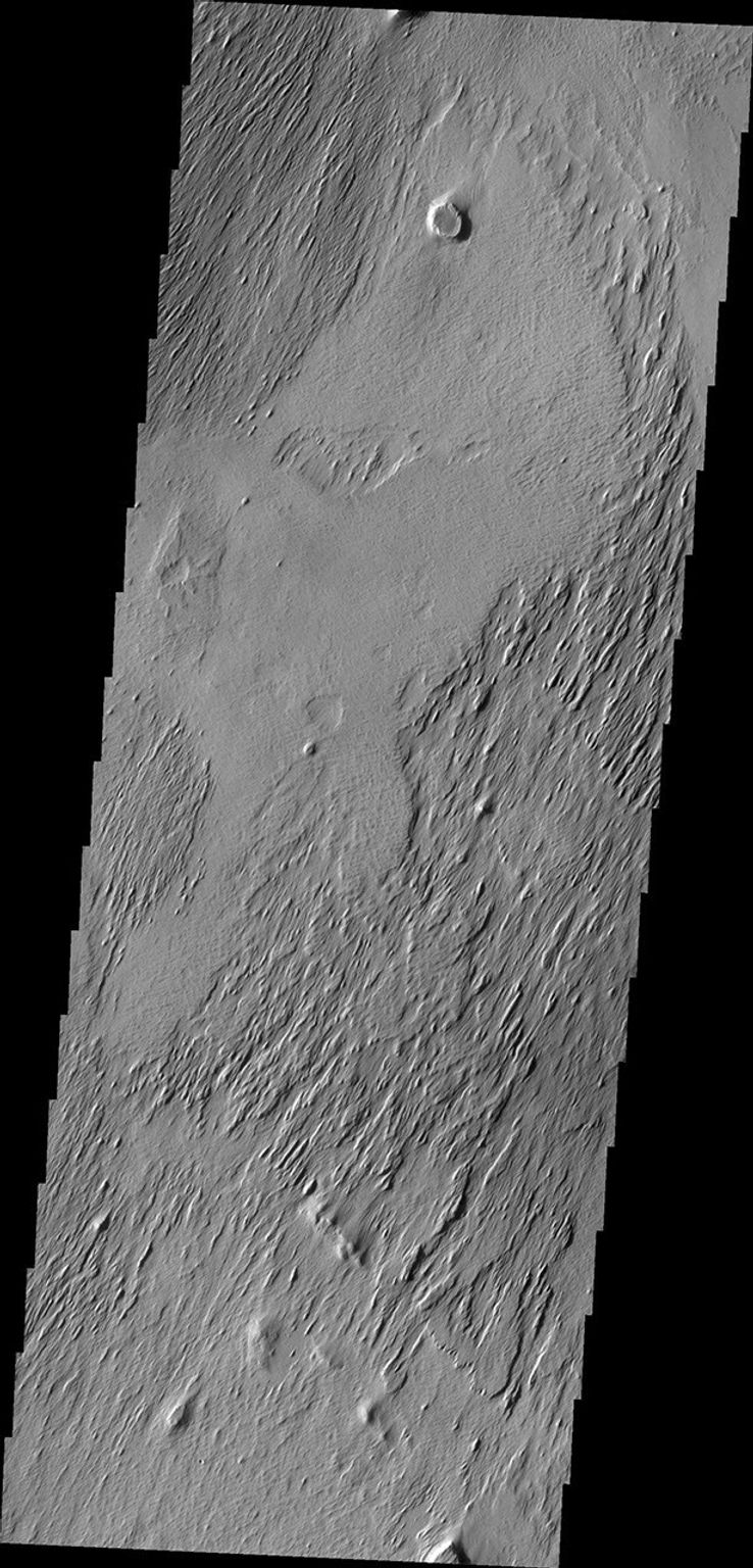 The action of the wind continues to shape the surface of Mars. This region has been eroded by the wind into parallel hills. This image from NASA's Mars Odyssey was captured on Sept. 6, 2010.