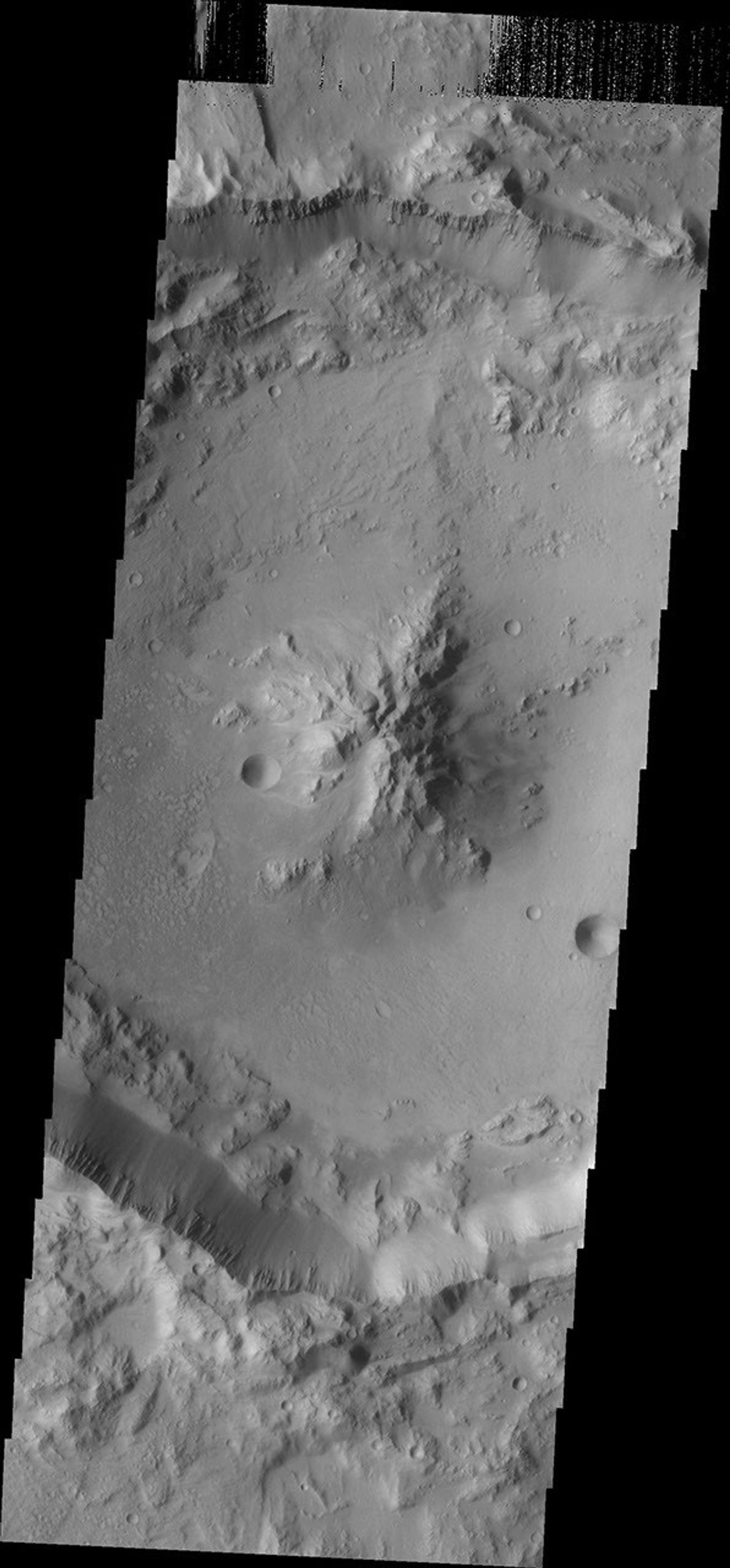 As crater size increases, craters become more complex. This moderate size crater contains a central peak, created by rebound of molten material just following the impact. This image was captured by NASA's Mars Odyssey on Sept. 8, 2010.