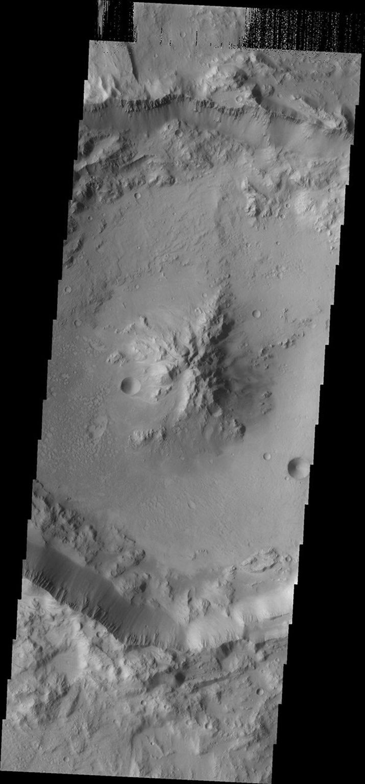 As crater size increases, craters become more complex. This moderate size crater contains a central peak, created by rebound of molten material just following the impact. This image was captured by NASA's Mars Odyssey on Sept. 8, 2010.