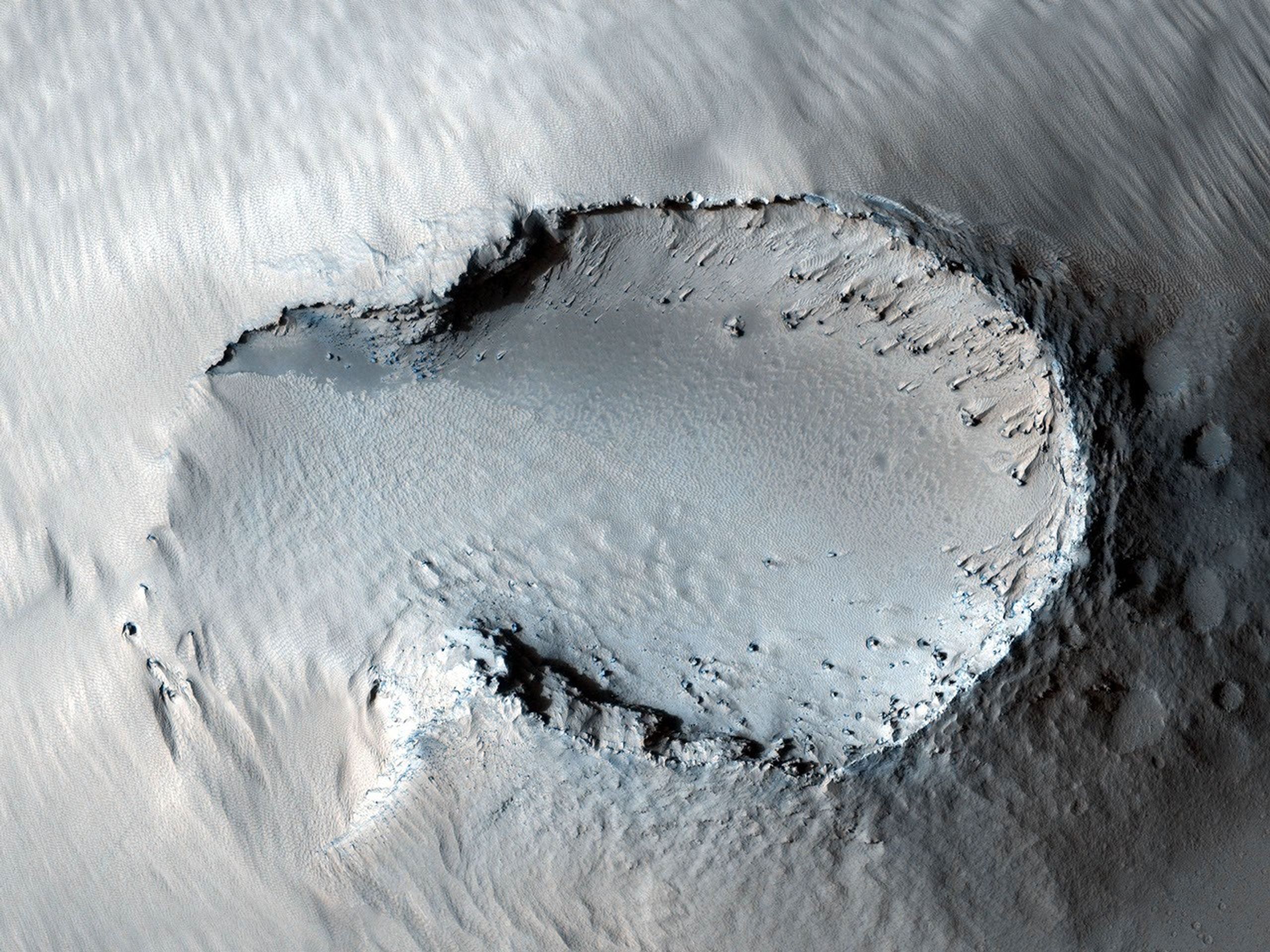This image from NASA's Mars Reconnaissance Orbite is centered on a small cone on the side of one of Mars' giant shield volcanoes. The cone shows some layers of hard rock but most of it is made of relatively soft material.
